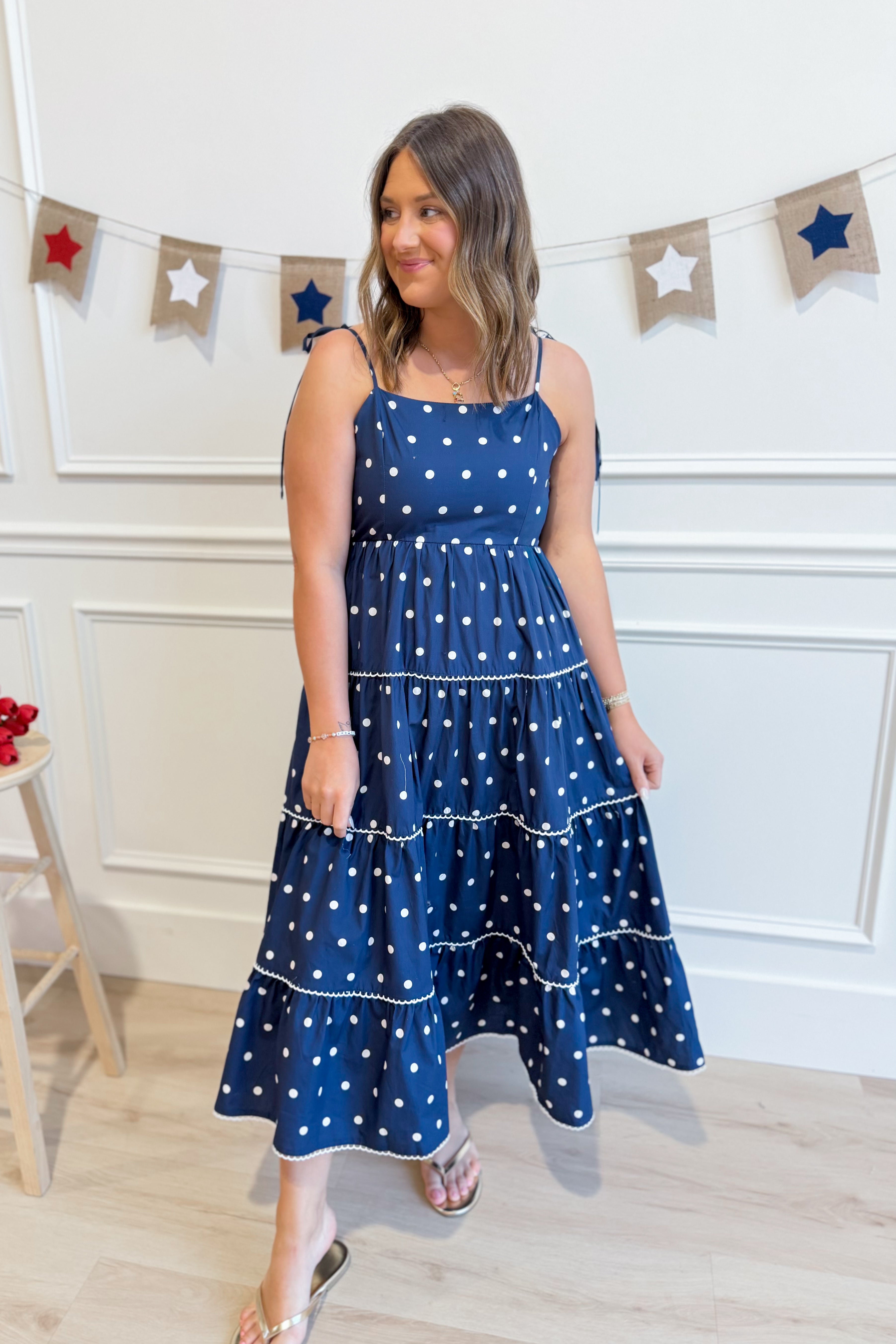 Vicki Polka Dot Tiered Midi Dress by PEACH LOVE, featuring a flowy silhouette and playful polka dot pattern.
