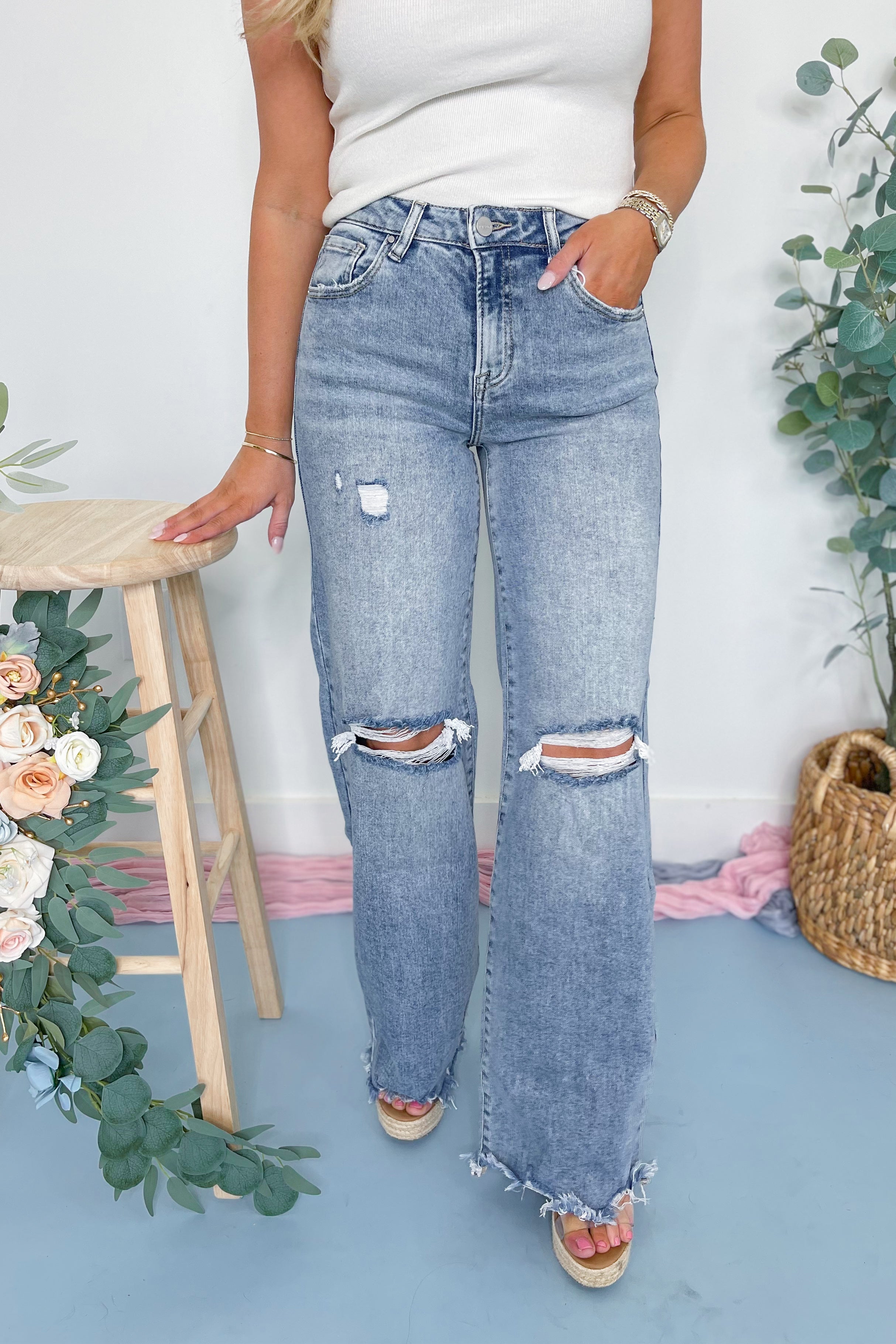 Risen Remi high rise wide-leg denim jeans in dark wash, displayed on a hanger, showcasing the relaxed fit and stylish cut.