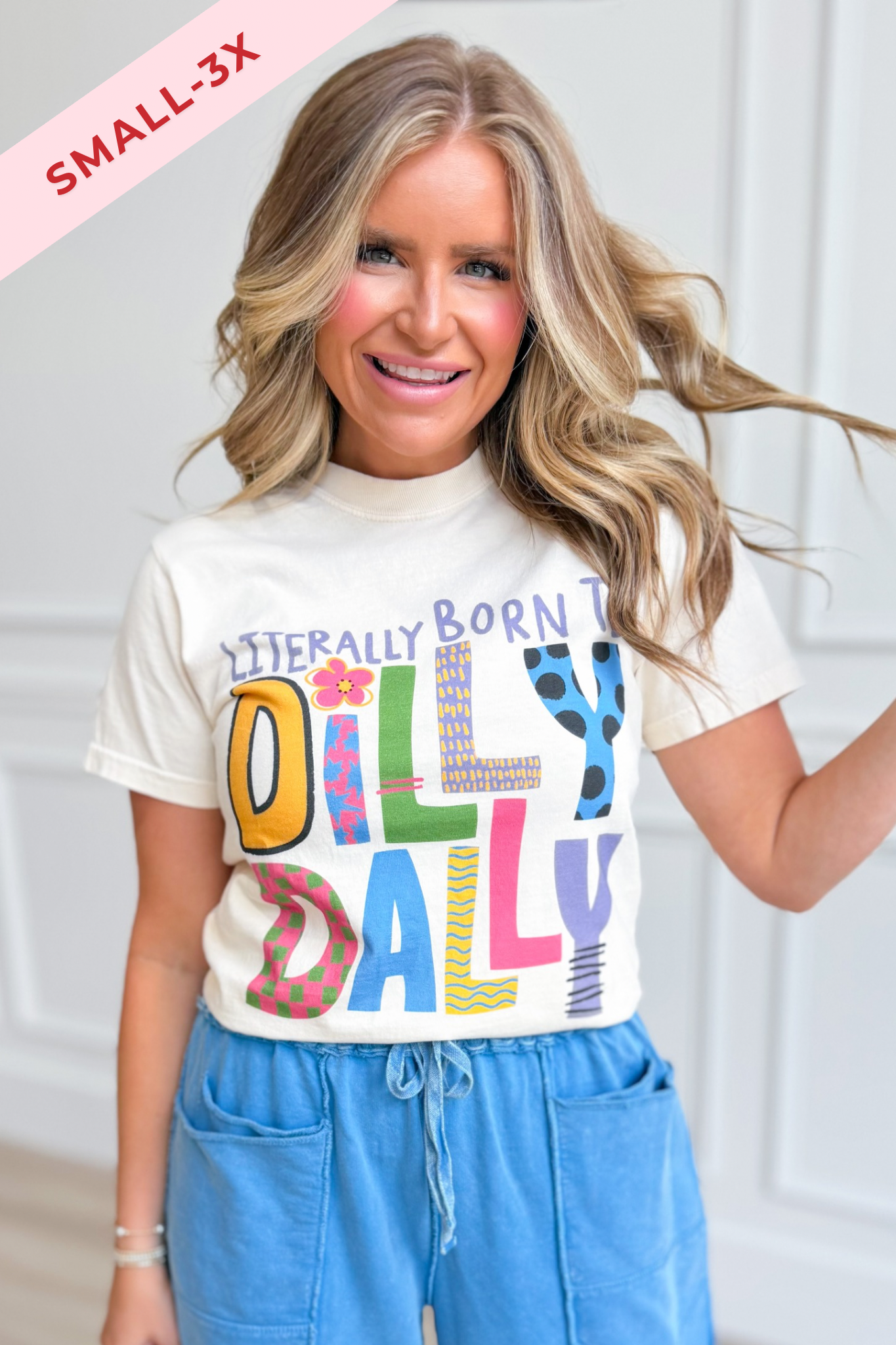 Black graphic T-shirt by POPPY & PINE featuring the "Literally Born To Dilly Dally" text design on the front.