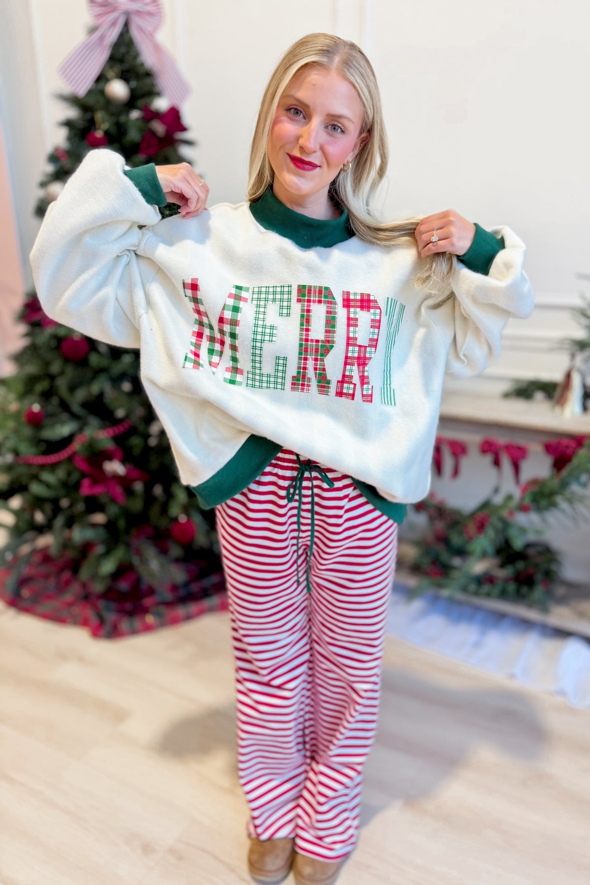Reversible green sweatshirt by PEACH LOVE featuring festive Merry and Striped graphic design, perfect for casual wear.