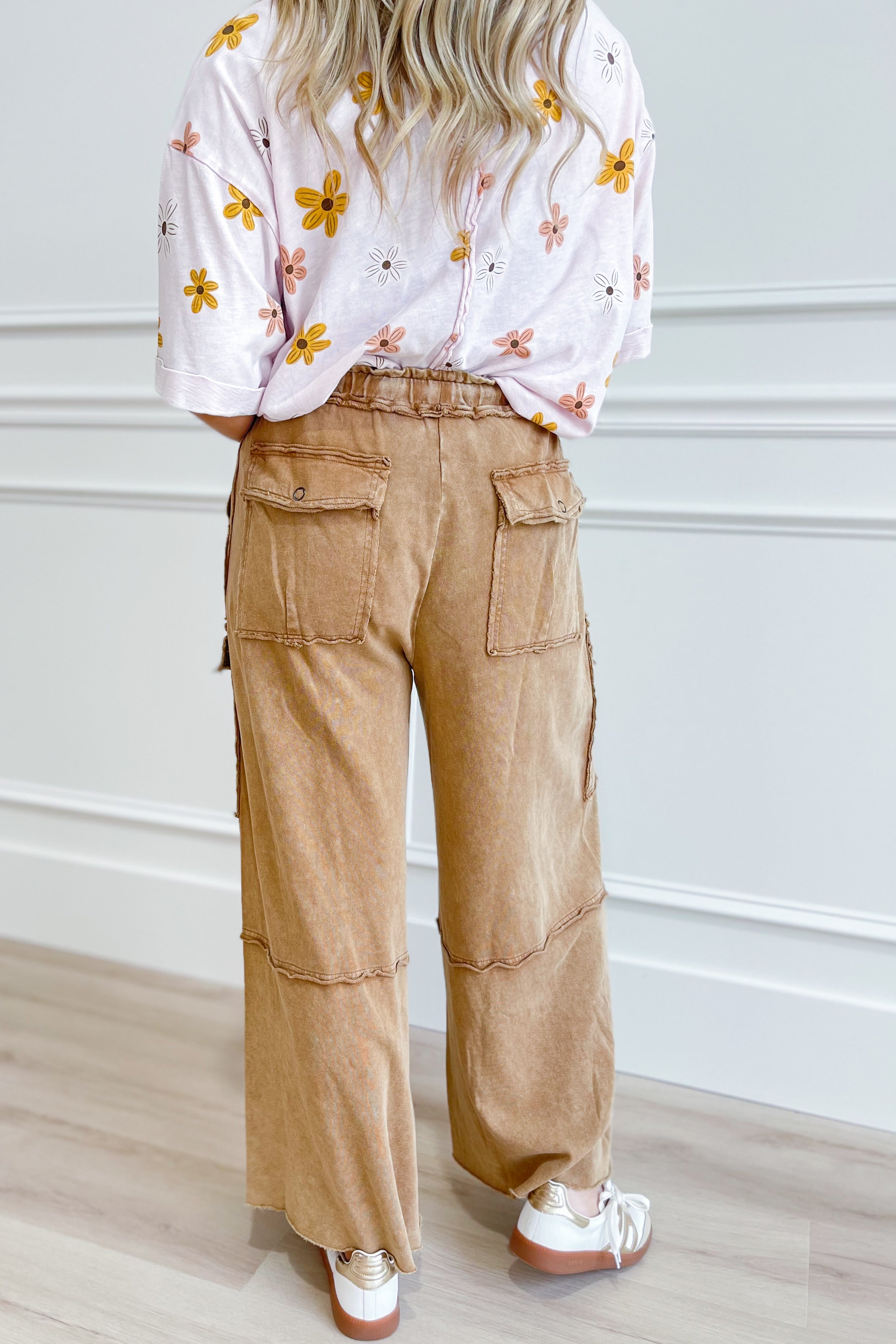 EASEL Mateo Mineral Washed Wide Leg Cargo Pants in olive green, relaxed fit with large side pockets, displayed on a hanger.