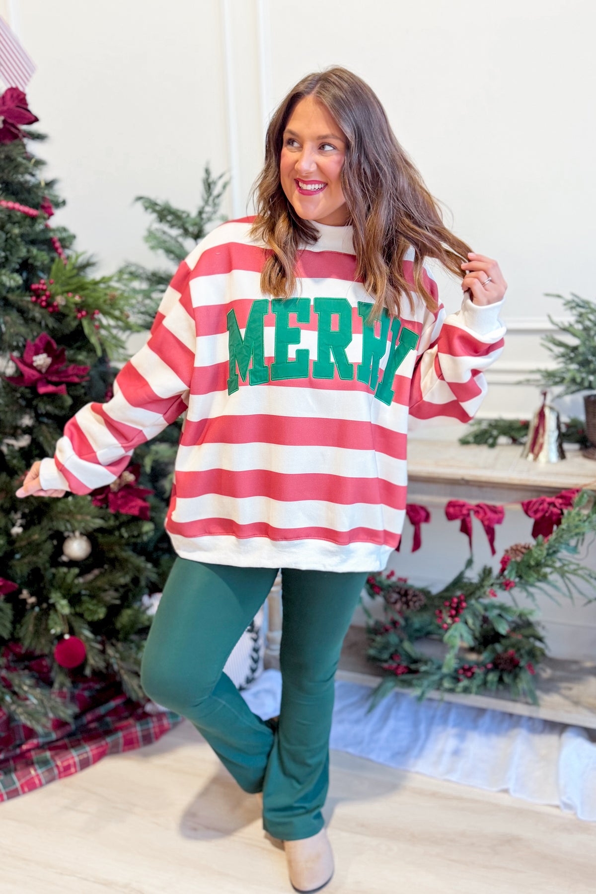 Embroidered Merry striped mock neck sweatshirt from BUCKET LIST, featuring colorful festive embroidery and a cozy graphic design.