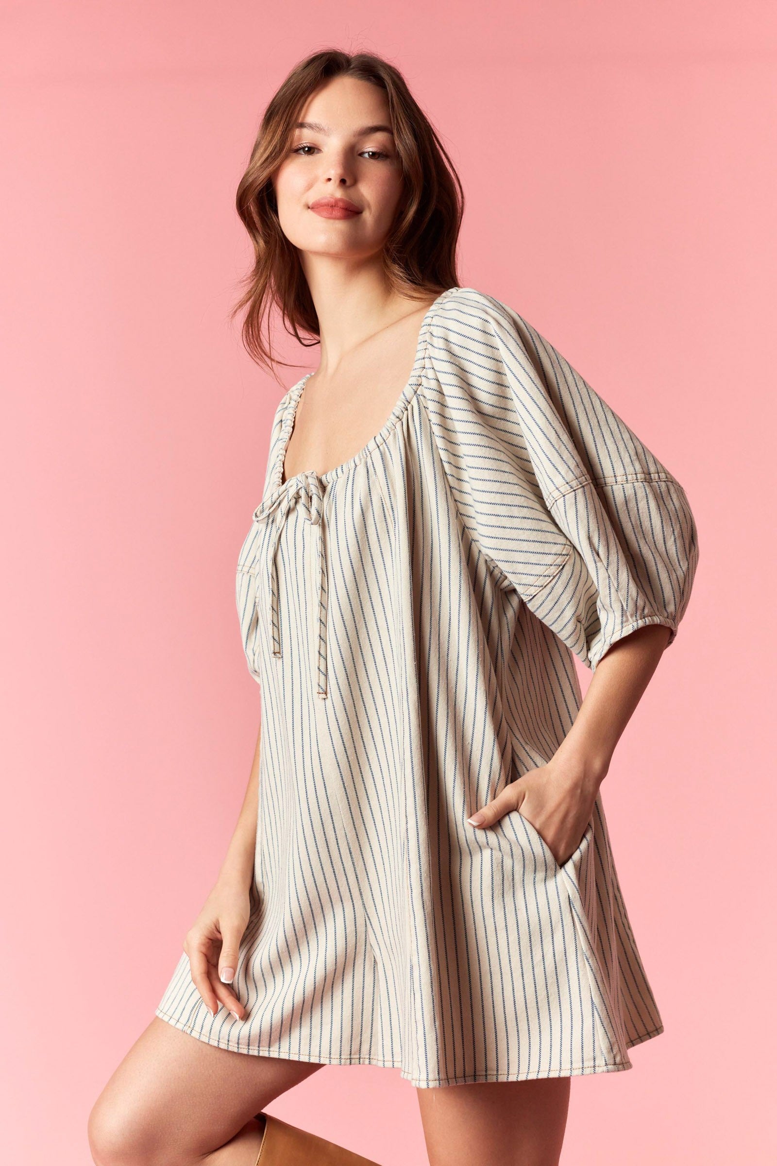 Peach Love Noah pin stripe oversized romper with relaxed fit, featuring a V-neck, short sleeves, and a tie waist detail.