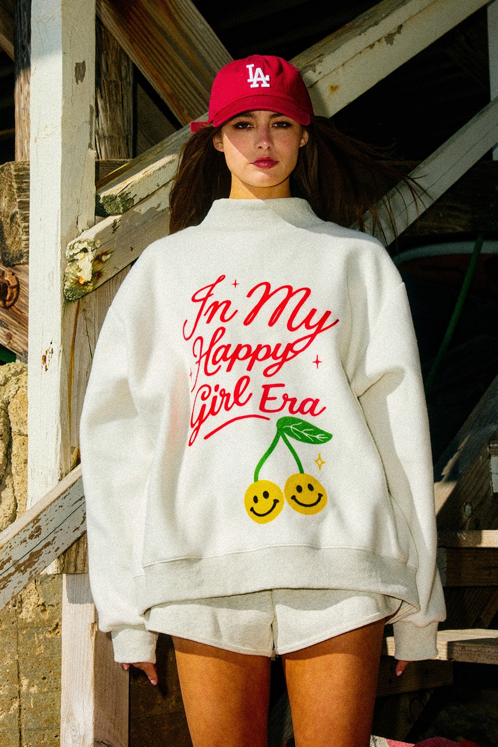 Black "In My Happy Girl Era" graphic sweatshirt by BUCKET LIST, featuring bold text and comfortable fit.