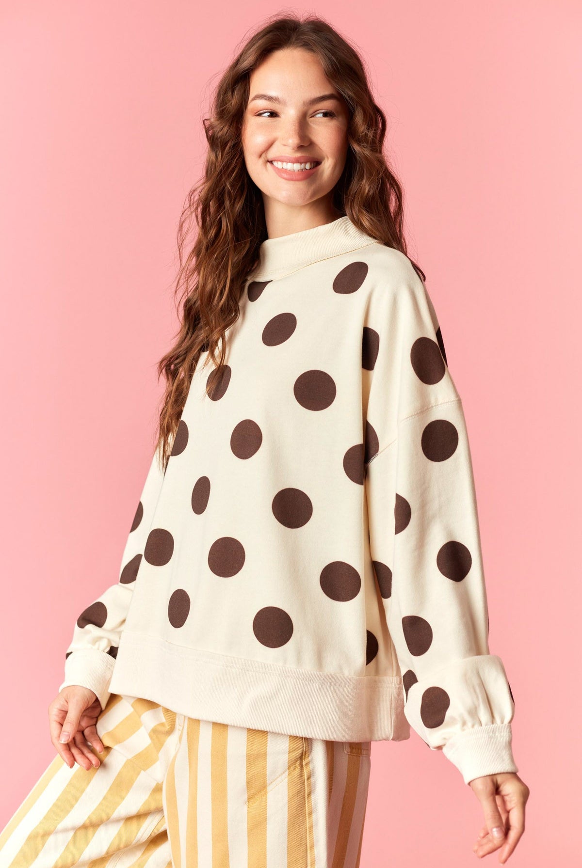 PEACH LOVE Lexie polka dot mock neck sweatshirt in black with white polka dots, long sleeves, and ribbed cuffs.