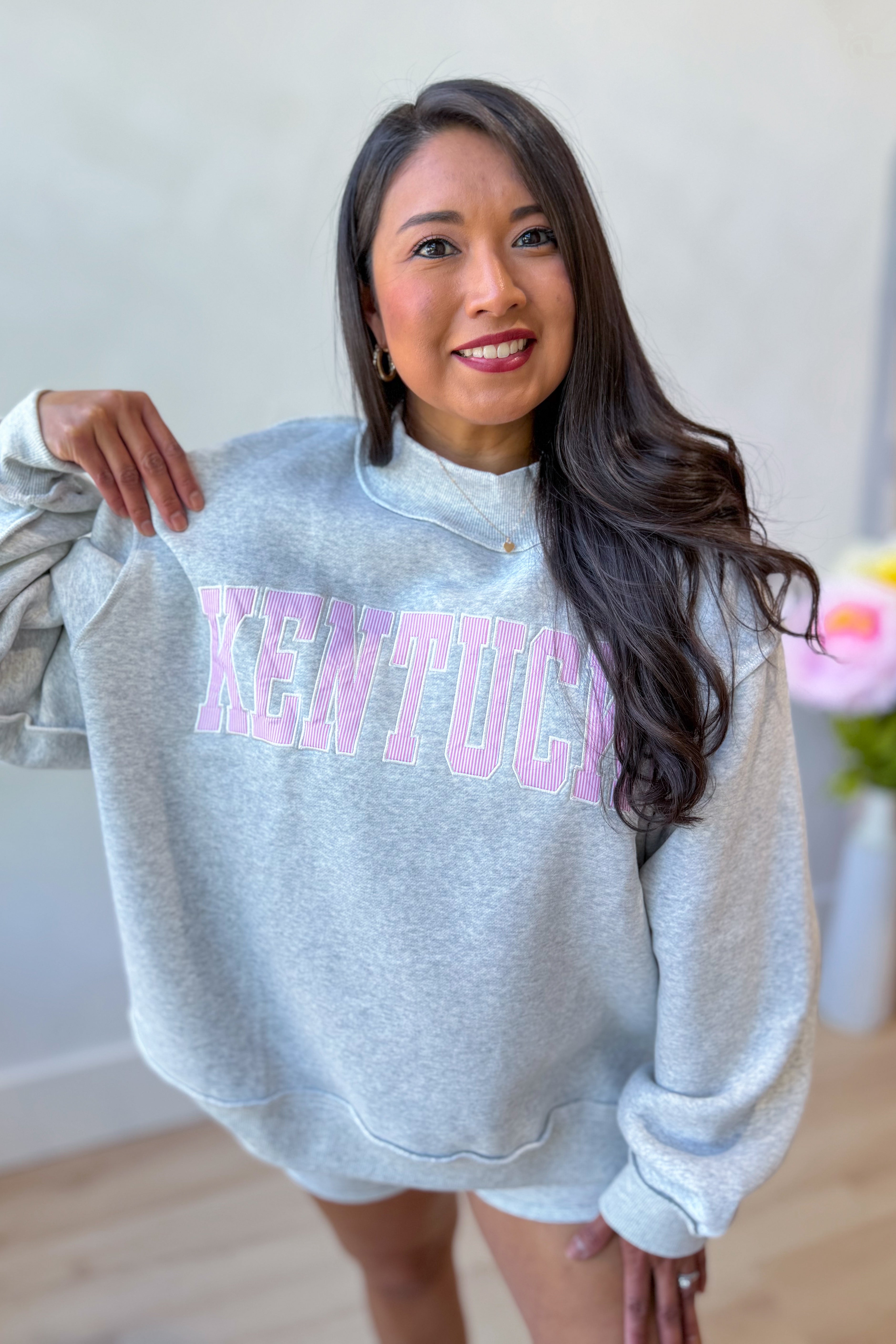 Kentucky pink striped mock embroidered sweatshirt from BUCKET LIST 137 Graphic Sweatshirts collection, showing front view with pink and white stripes.