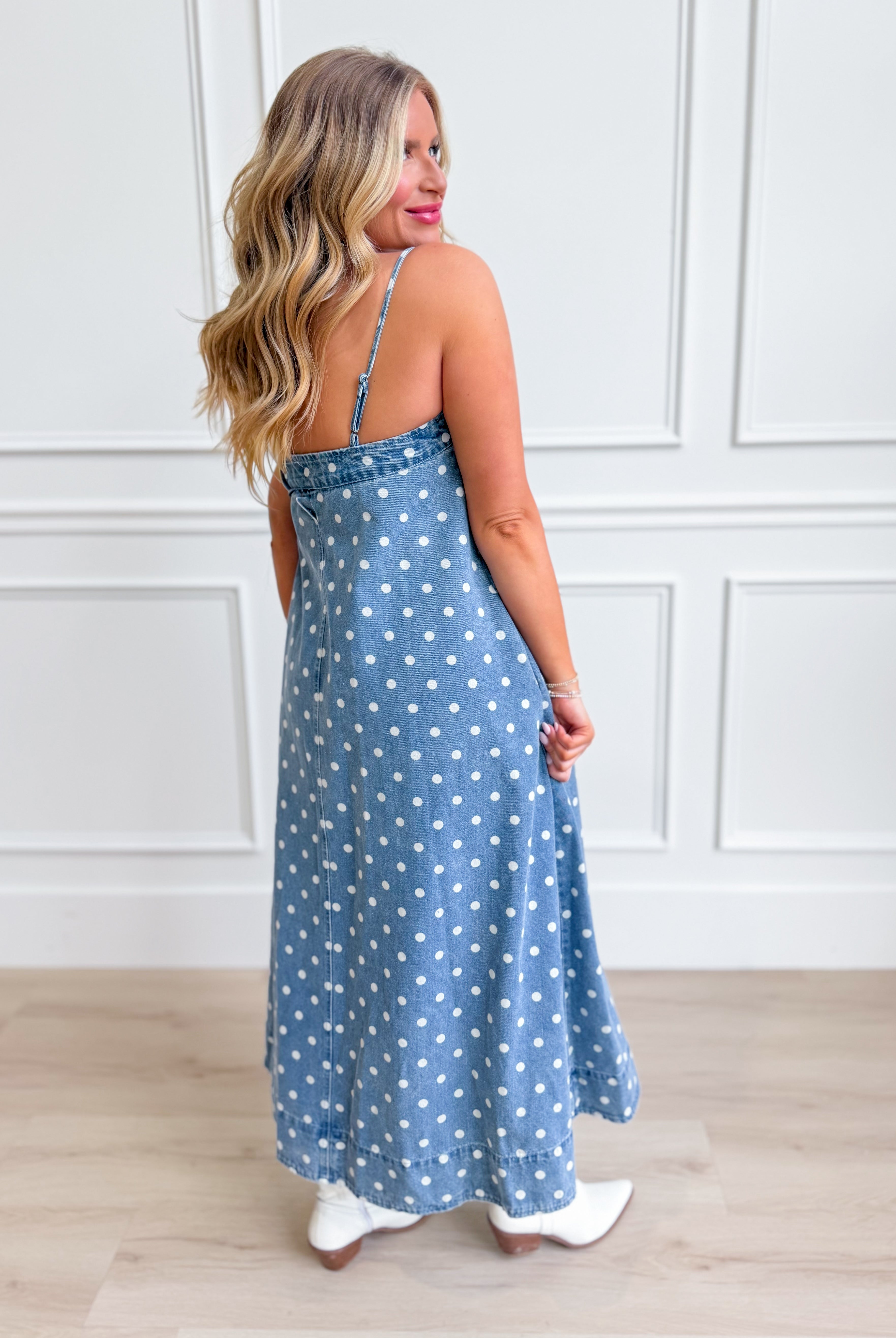 Aureum Mia polka dot denim dress displayed on a hanger, featuring a classic fit, short sleeves, and playful polka dot pattern.