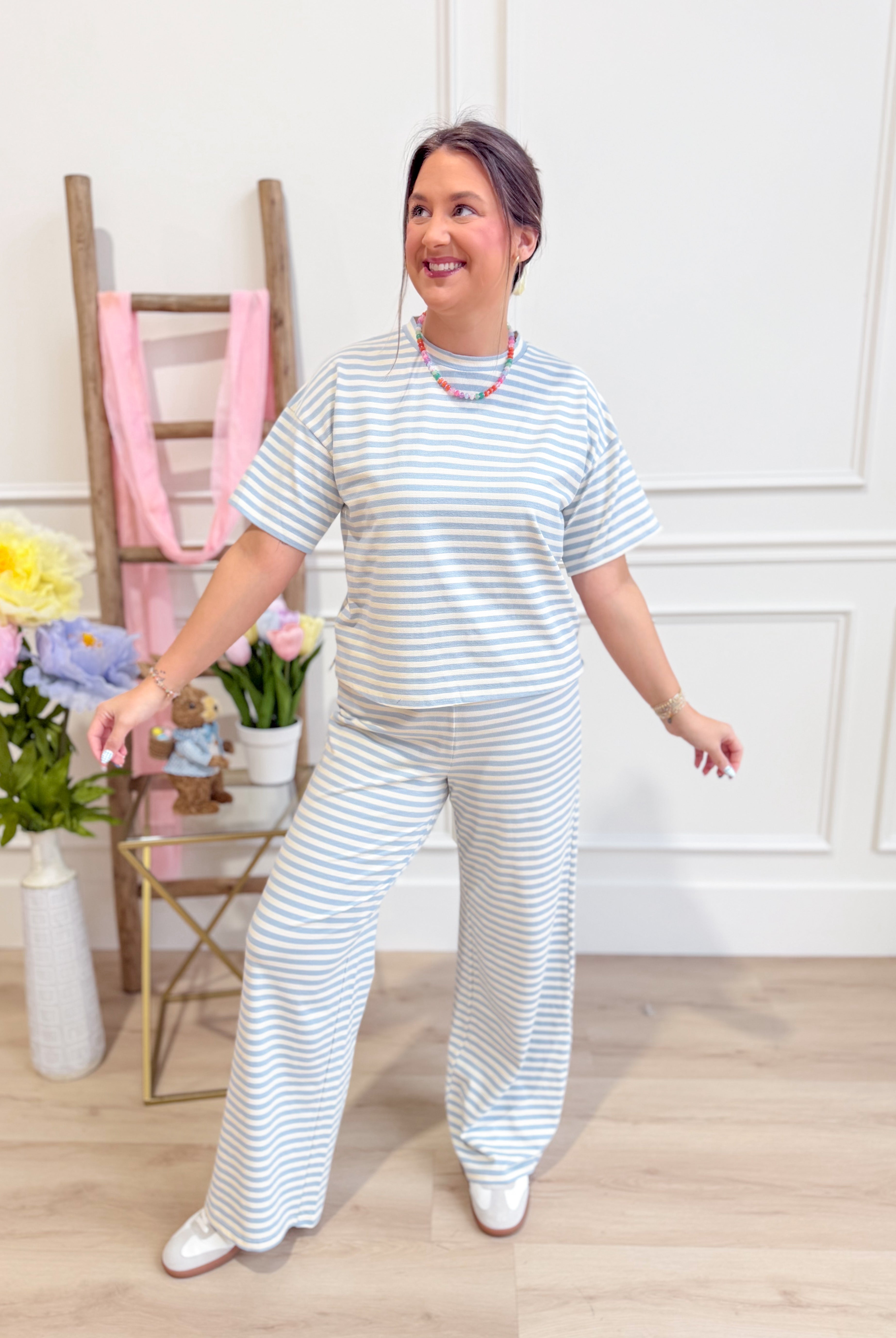Light blue striped casual top by THINGS BETWEEN, featuring a relaxed fit and soft fabric, perfect for everyday wear.