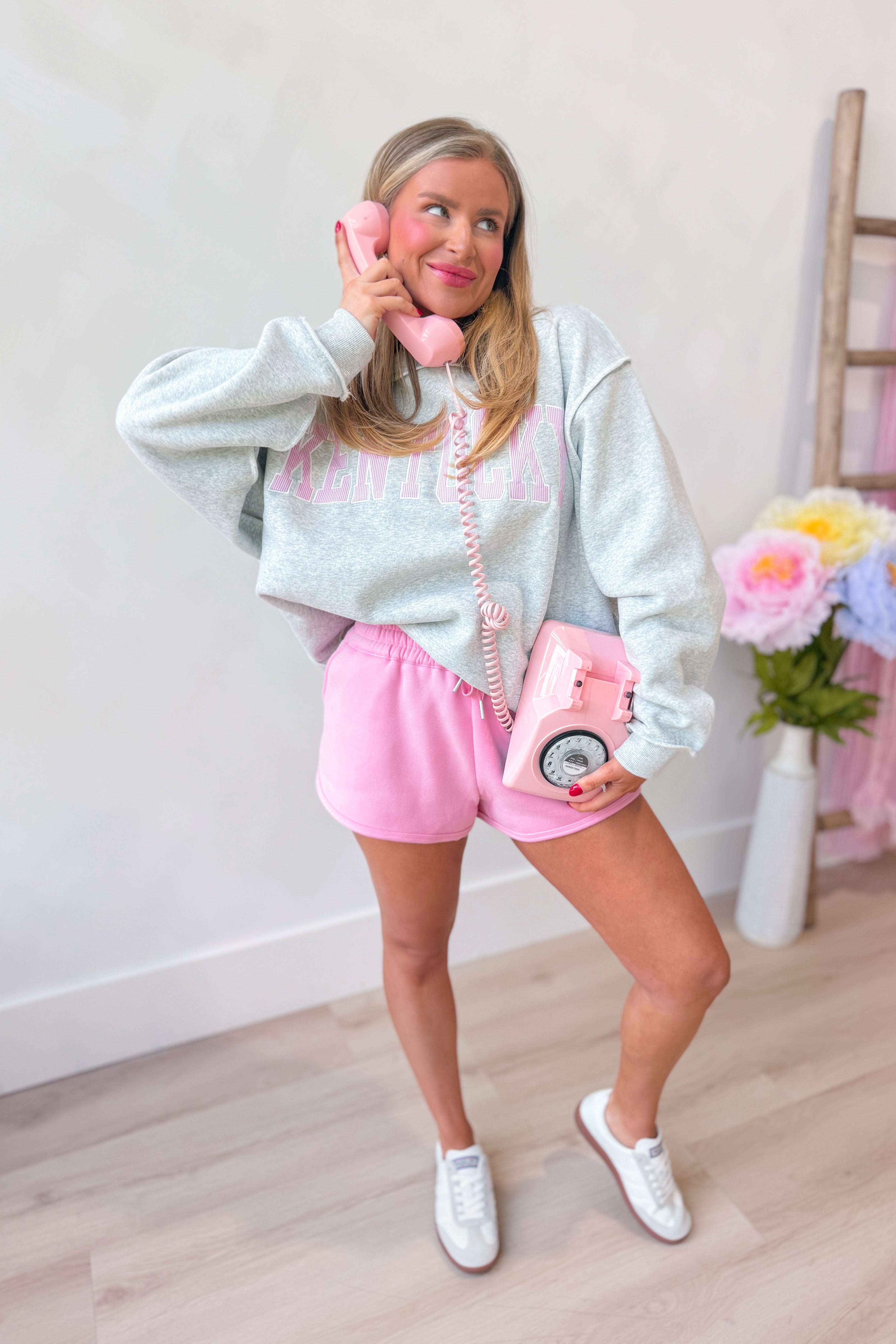 Kentucky Pink Striped Mock Embroidered Sweatshirt from BUCKET LIST, featuring pink stripes and embroidered details on a casual graphic sweatshirt.