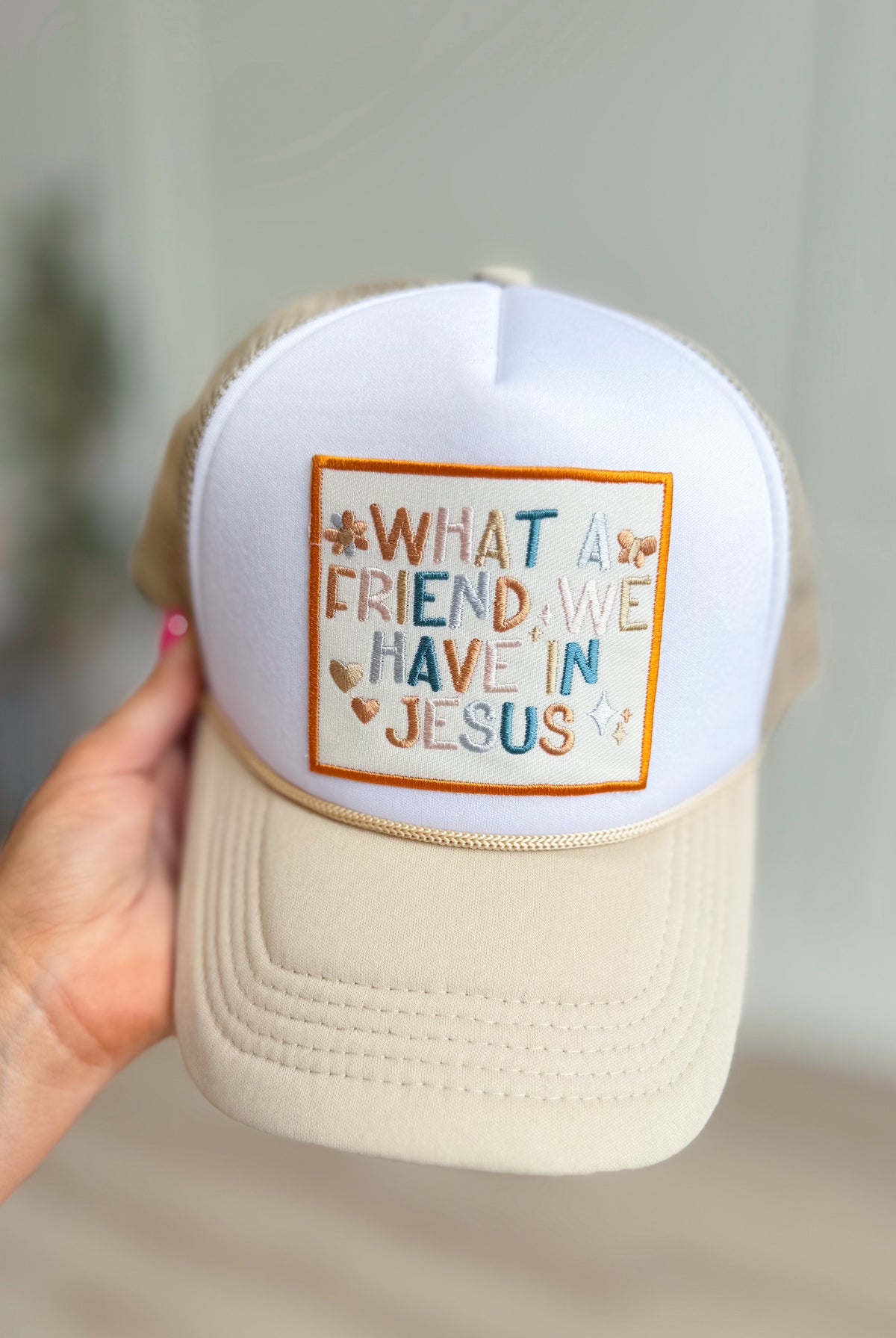 Gospel Gear Co embroidered foam trucker hat with "What A Friend In Jesus" design and adjustable strap, casual headwear accessory.