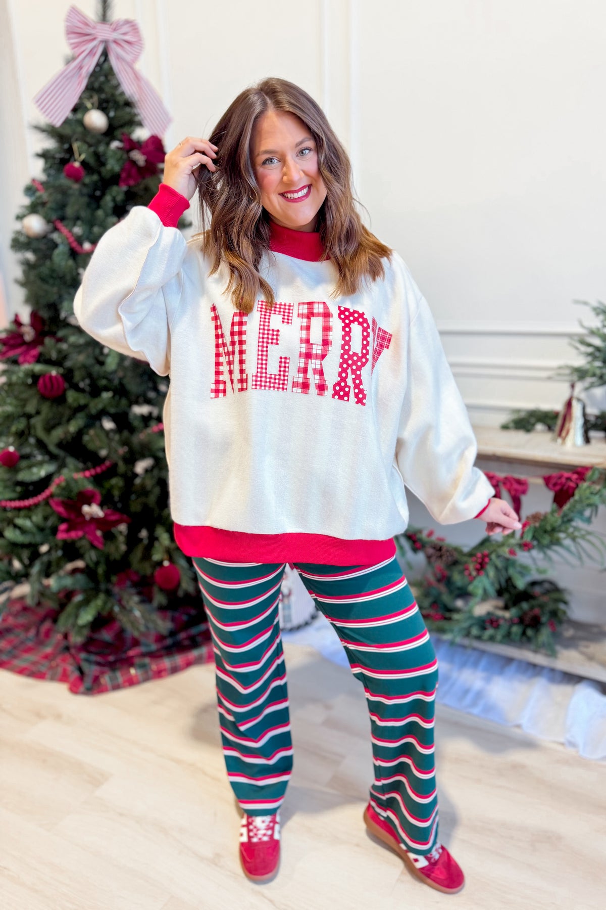 Reversible red and striped Merry and Graphic Sweatshirt by PEACH LOVE featuring festive holiday design and comfortable fit.