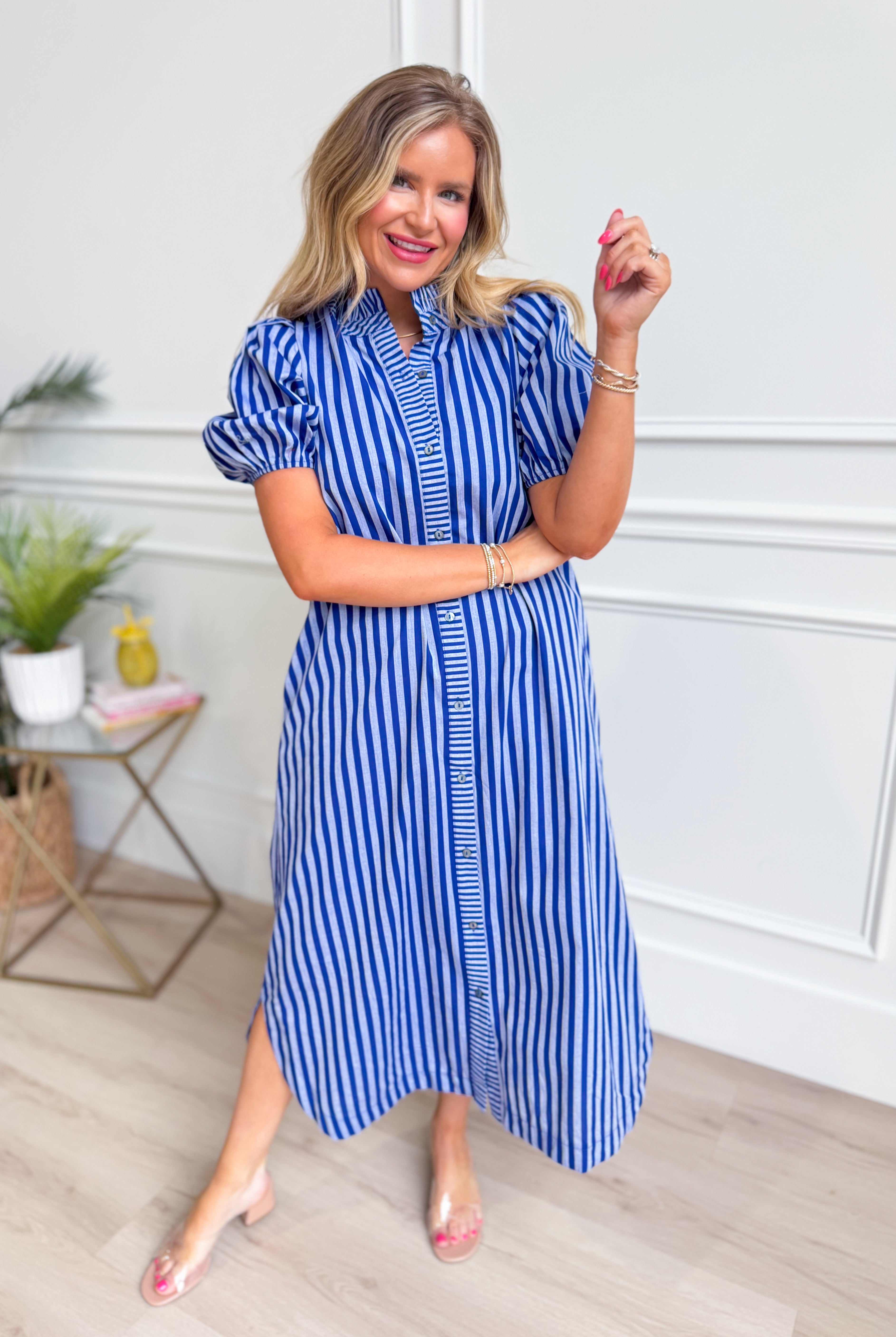 Susie striped midi dress by ENTRO featuring a casual design, with a fitted bodice and flowing skirt, displayed on a hanger.