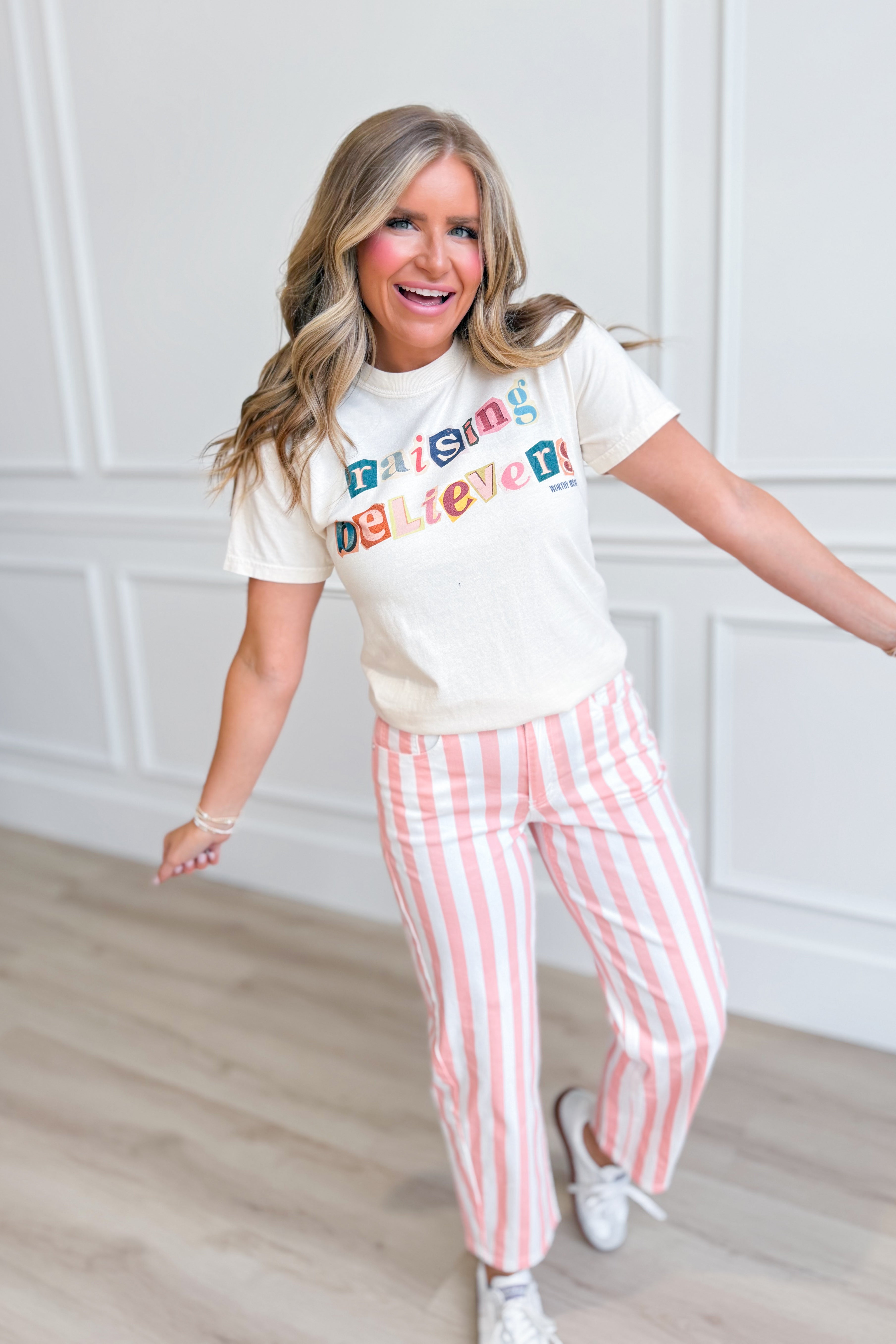 Raising Believers graphic T-shirt by Worthy Wear featuring a colorful inspirational design on a casual 117 graphic tee
