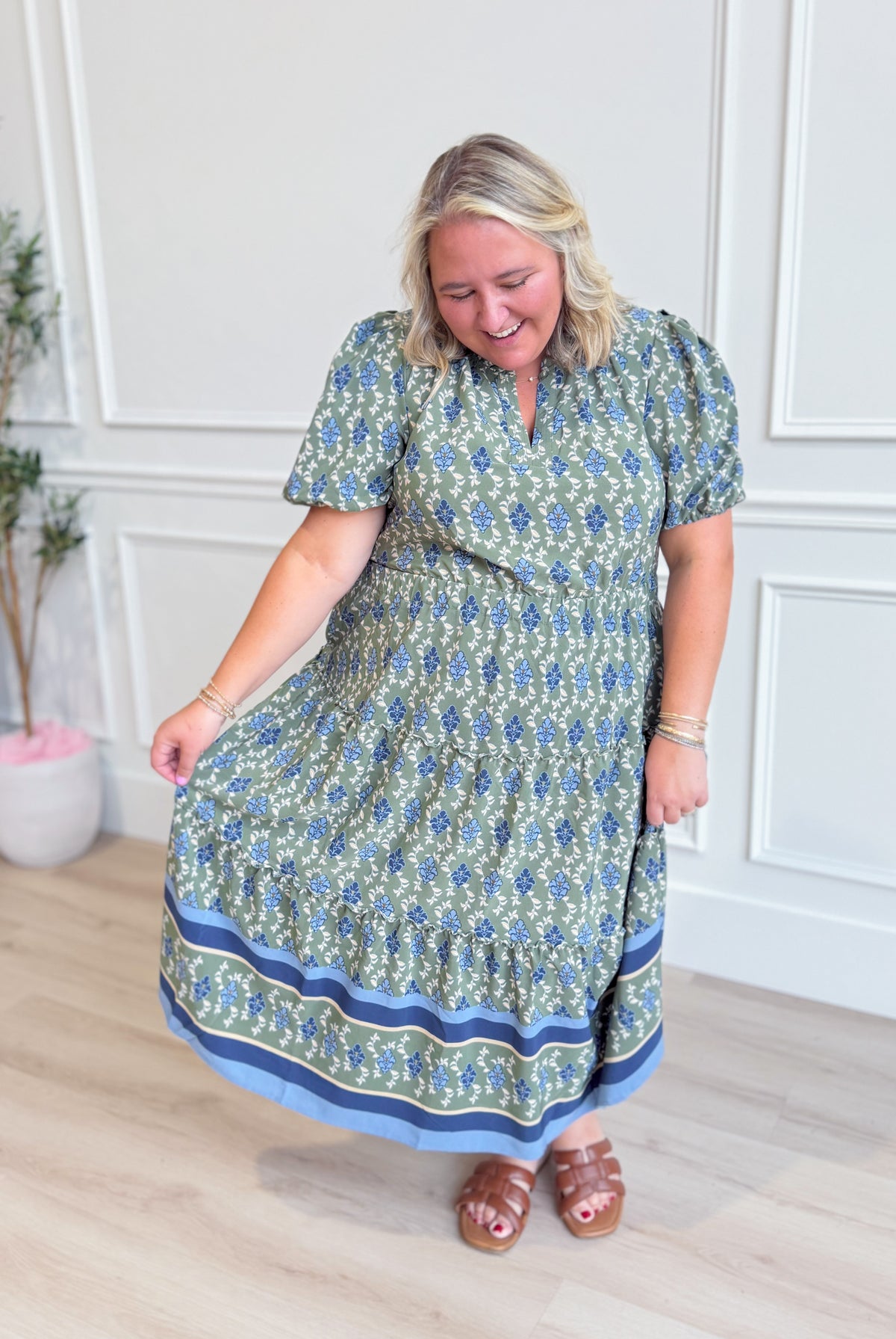 Mary Square Lainey floral puff sleeve midi dress with a fitted bodice and flowy skirt, featuring a vibrant floral pattern.