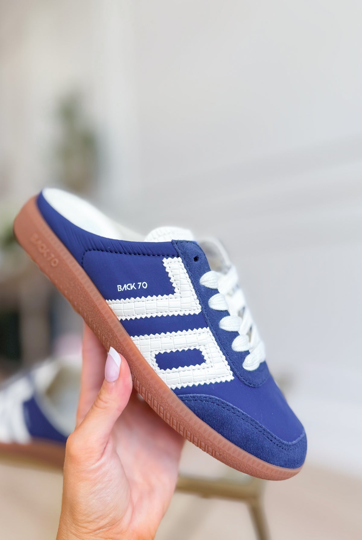 Backless navy Easter sneaker from BACK 70, featuring a sleek low-cut design and 205 sneakers style, displayed on a white background.