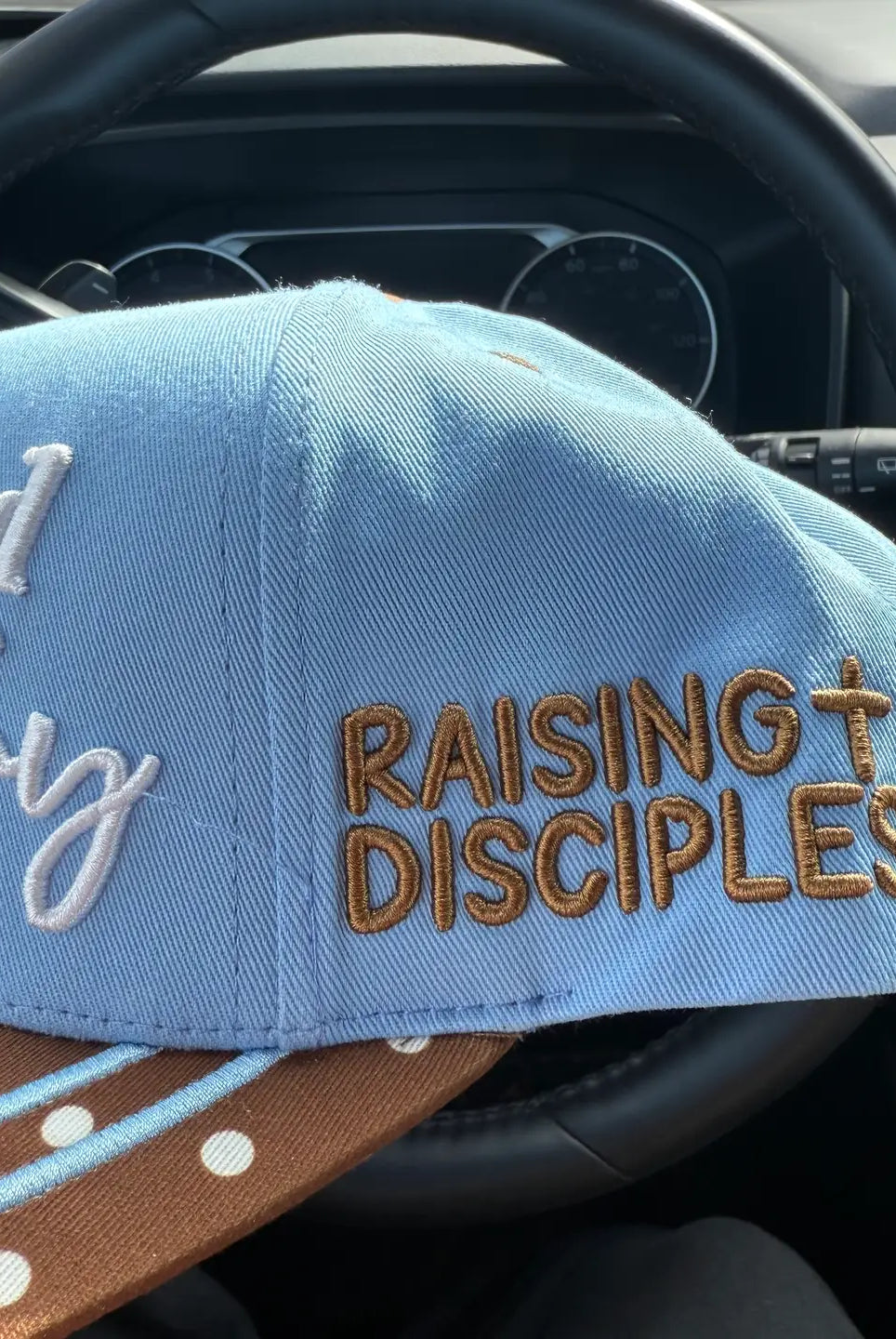 Broke Babe Motherhood Is My Ministry trucker hat with mesh back and embroidered text, stylish accessory for moms.