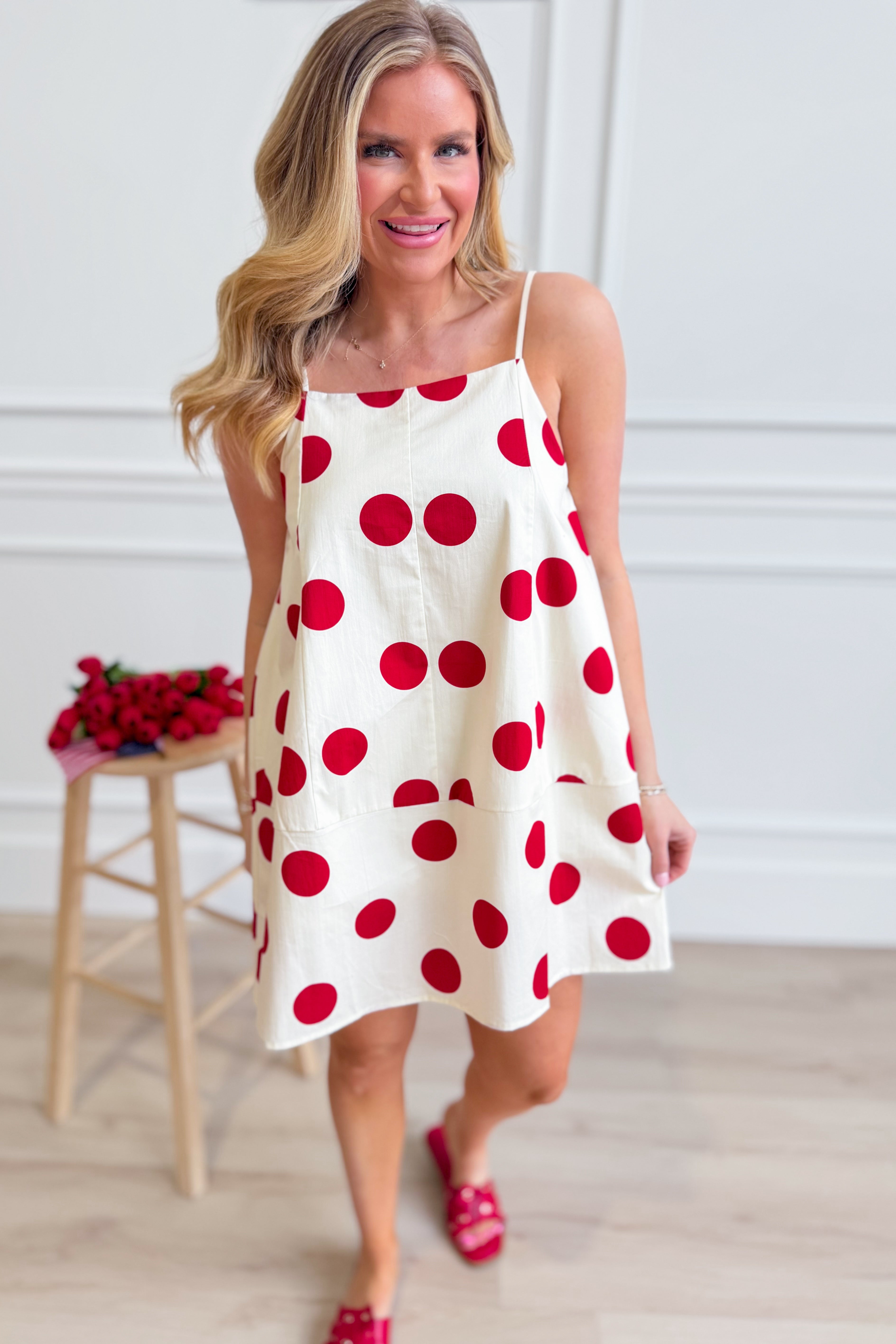 PEACH LOVE Jenna polka dot summer dress with sleeveless design and flowy fabric, perfect for warm weather occasions.