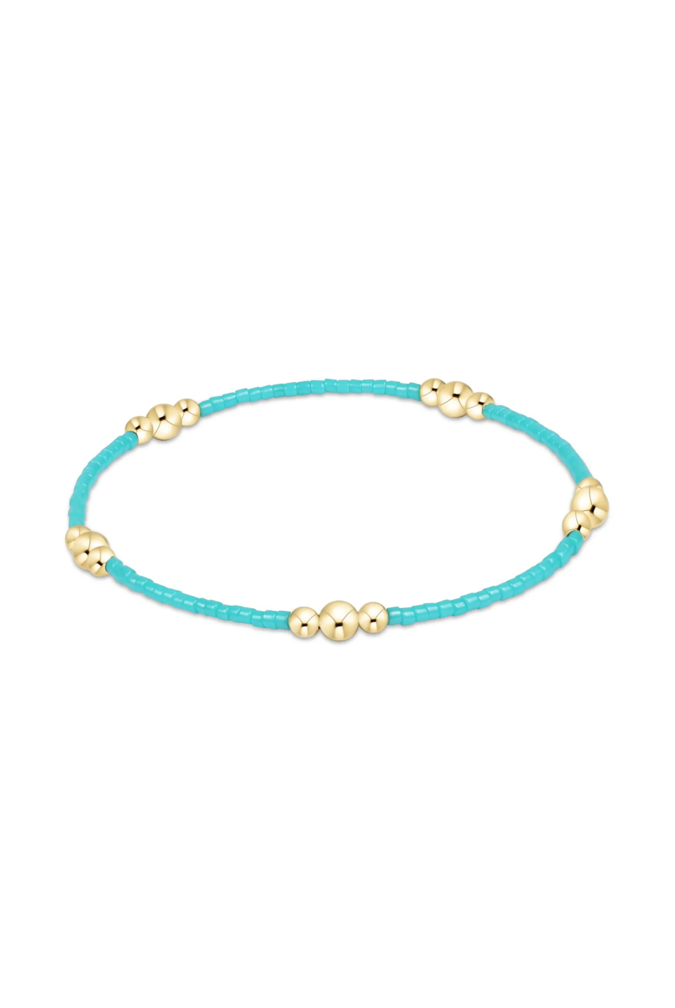 Enewton turquoise hope and purpose gold bracelet with a delicate chain and turquoise bead accents on a jewelry display.