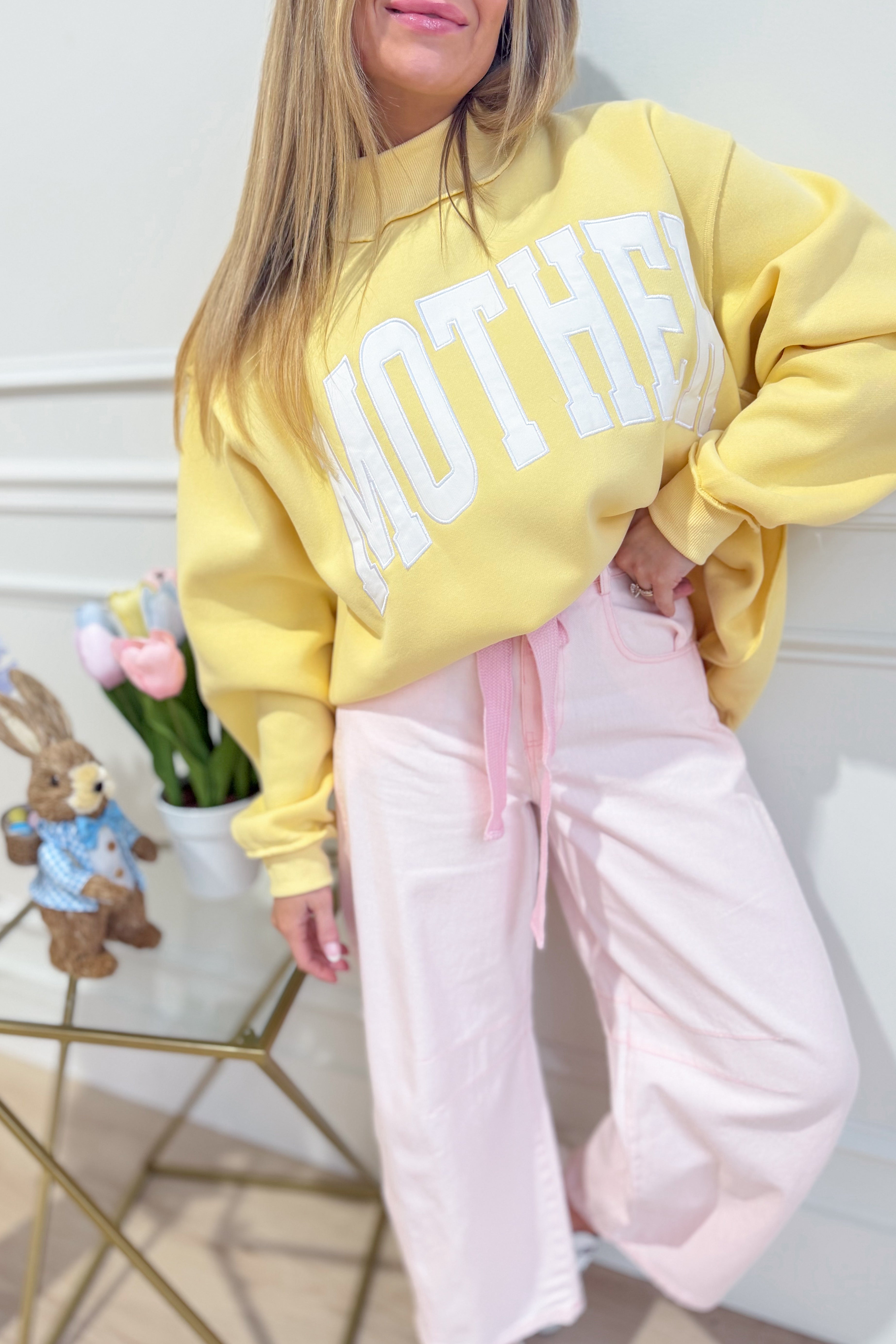 Light pink mineral-washed eyelet barrel jeans from PEACH LOVE's 147 Novelty Jeans collection, shown with detailed eyelet accents.