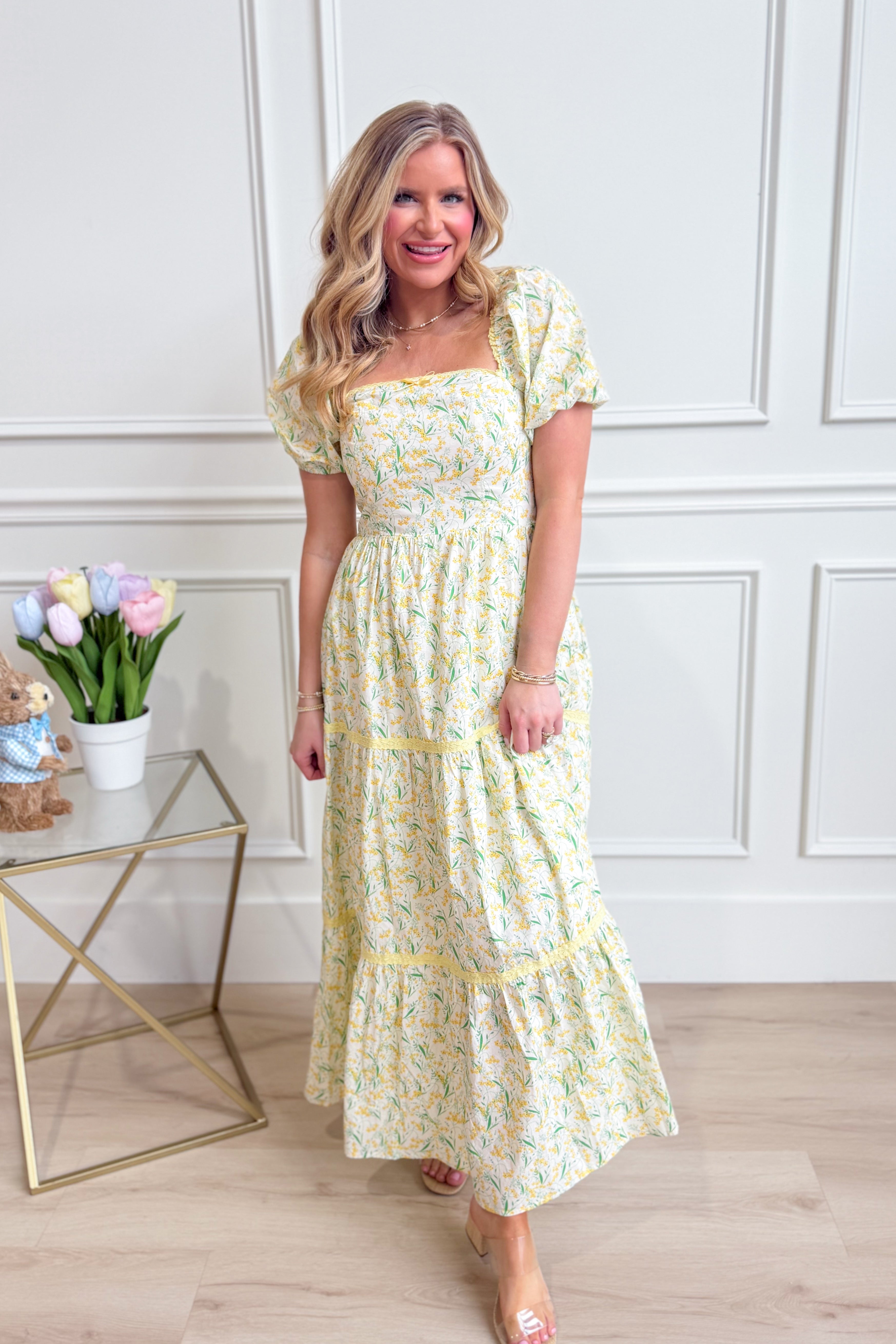 IN LOOM Bloom floral square neck maxi dress displayed on a model, featuring a flowy silhouette and vibrant floral pattern.