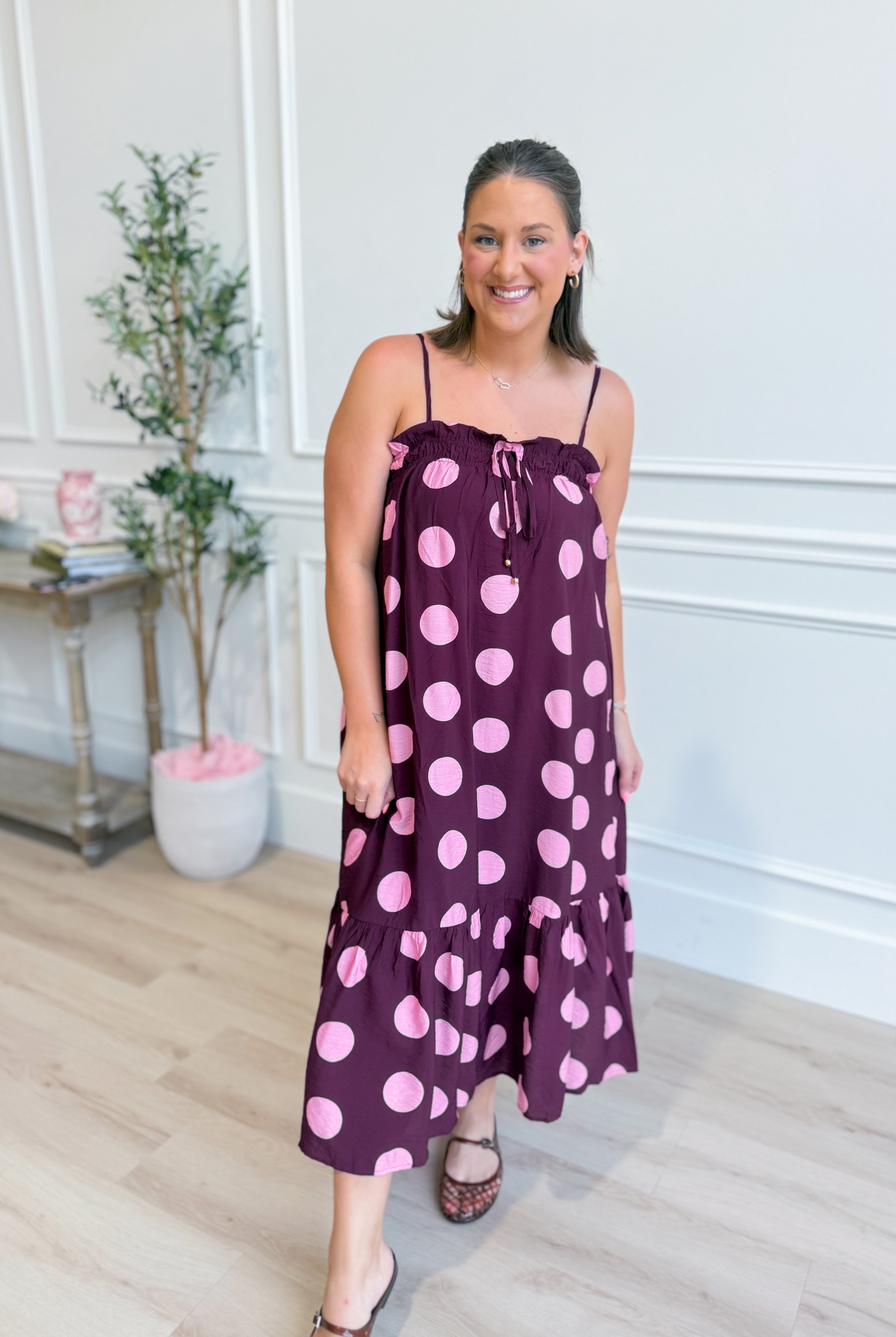 ENTRO Ashton polka dot midi dress featuring a classic design, sleeveless style, and a flattering fit, perfect for dressy occasions.