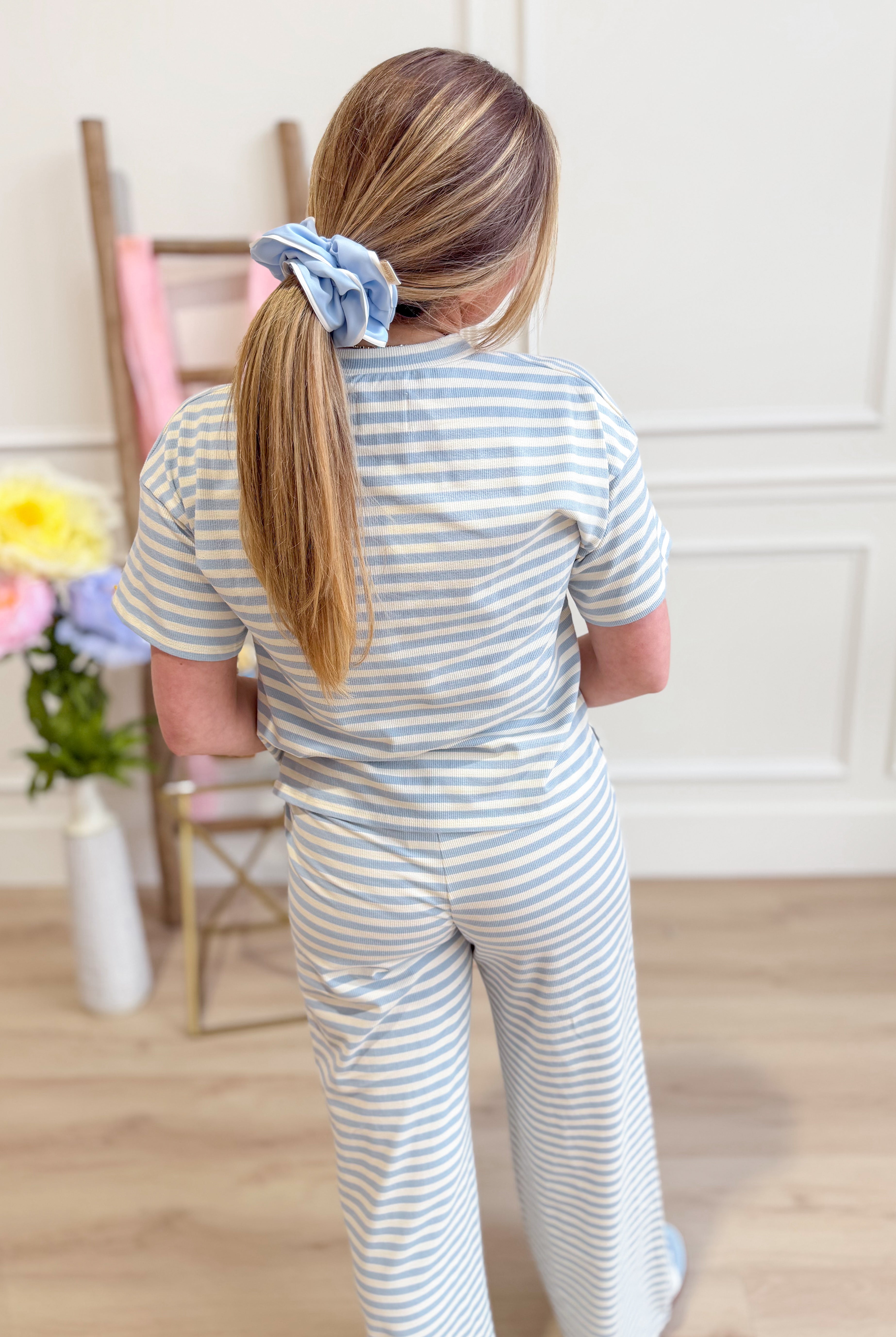 Light blue striped casual top by THINGS BETWEEN, featuring a relaxed fit and soft fabric, perfect for everyday wear.