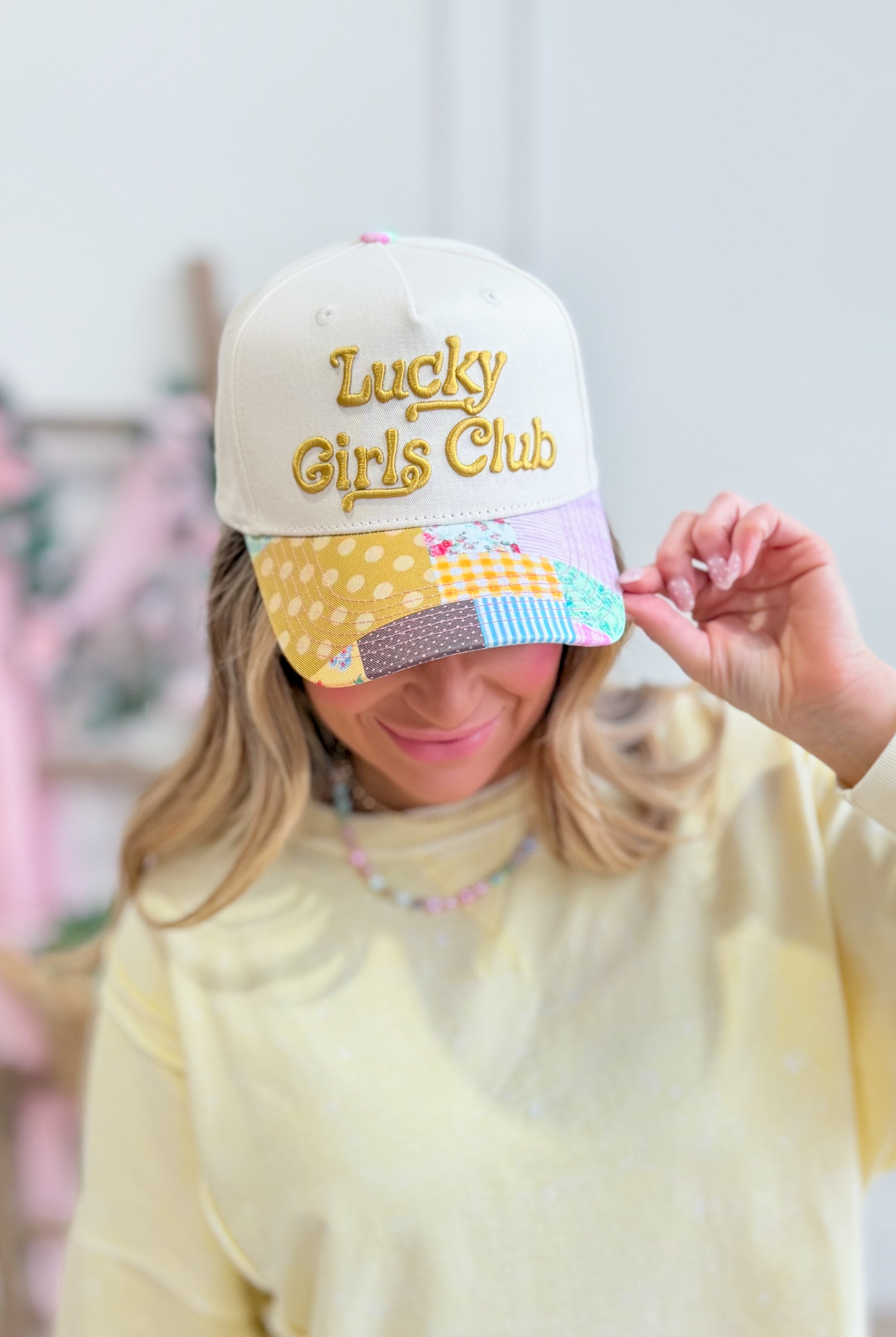 ETTA & EAST Lucky Girls Club trucker hat featuring a stylish design, mesh back, and adjustable snap closure.