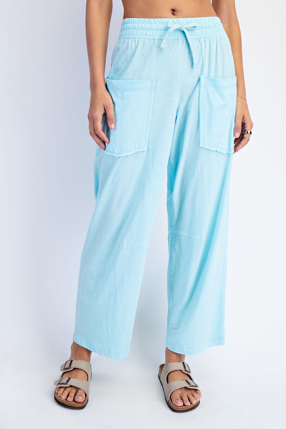Raé Mode Bella Cotton Barrel Pant in beige, featuring a relaxed fit with a high waist and wide-leg design, shown on a model.