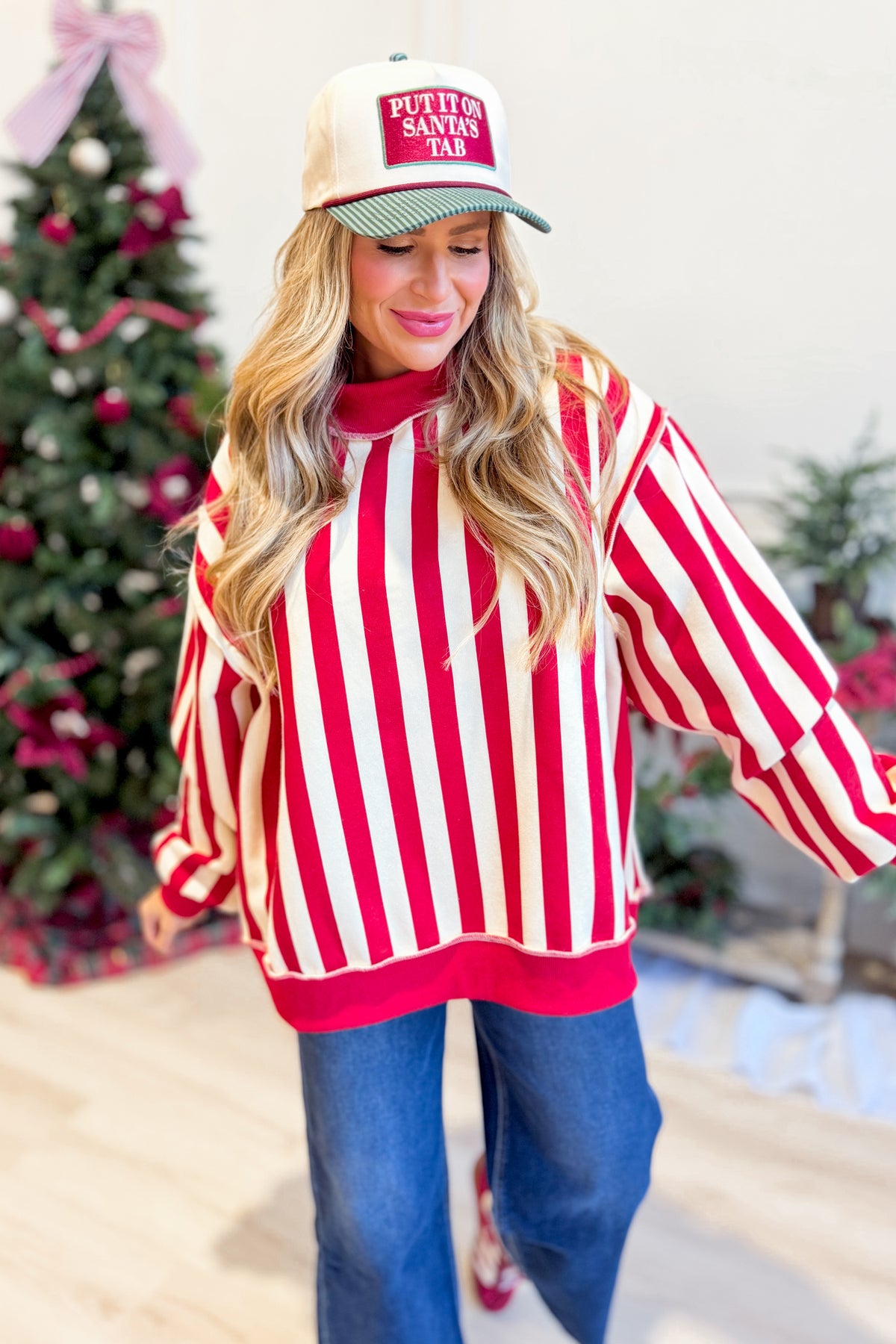 Red and white striped reversible sweatshirt from PEACH LOVE, featuring a festive merry graphic on the front.