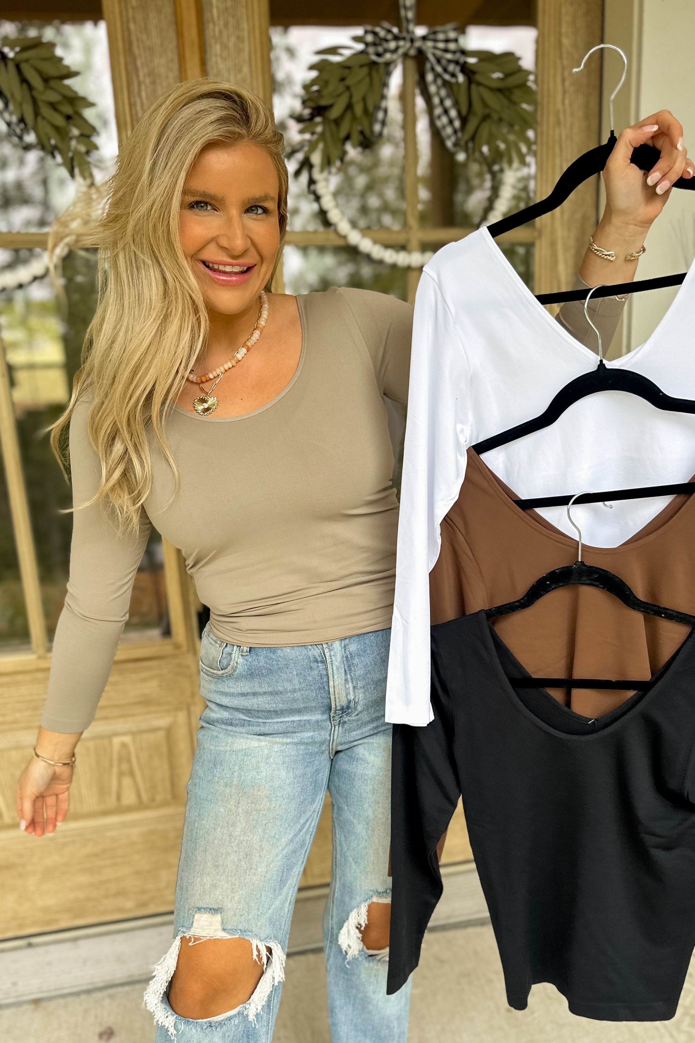 Yelete Katie seamless reversible long sleeve top in black and gray, shown flat with smooth fabric and simple neckline.