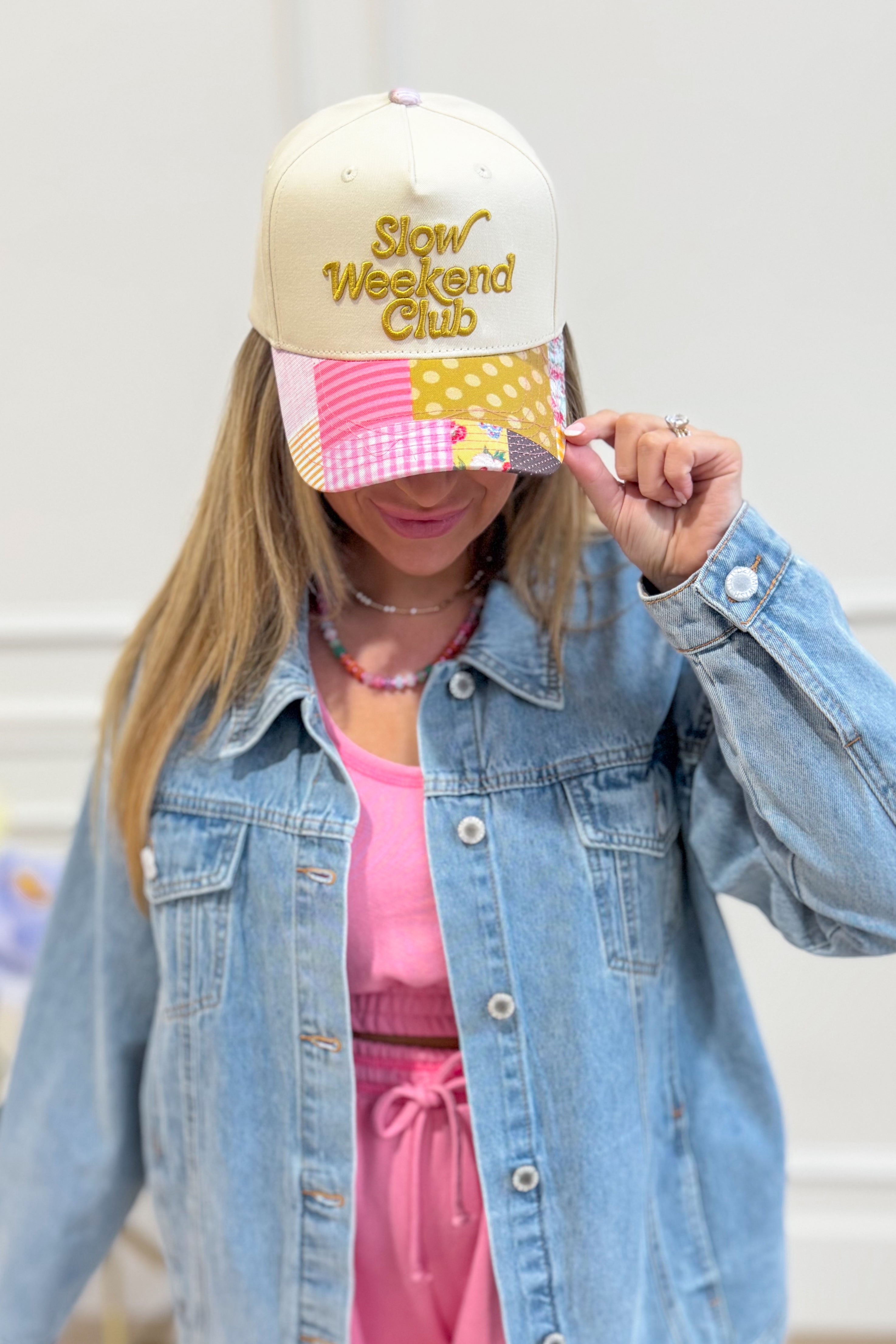 ETTA & EAST Slow Weekend Club trucker hat with mesh back and embroidered front design, casual accessory for outdoor wear.