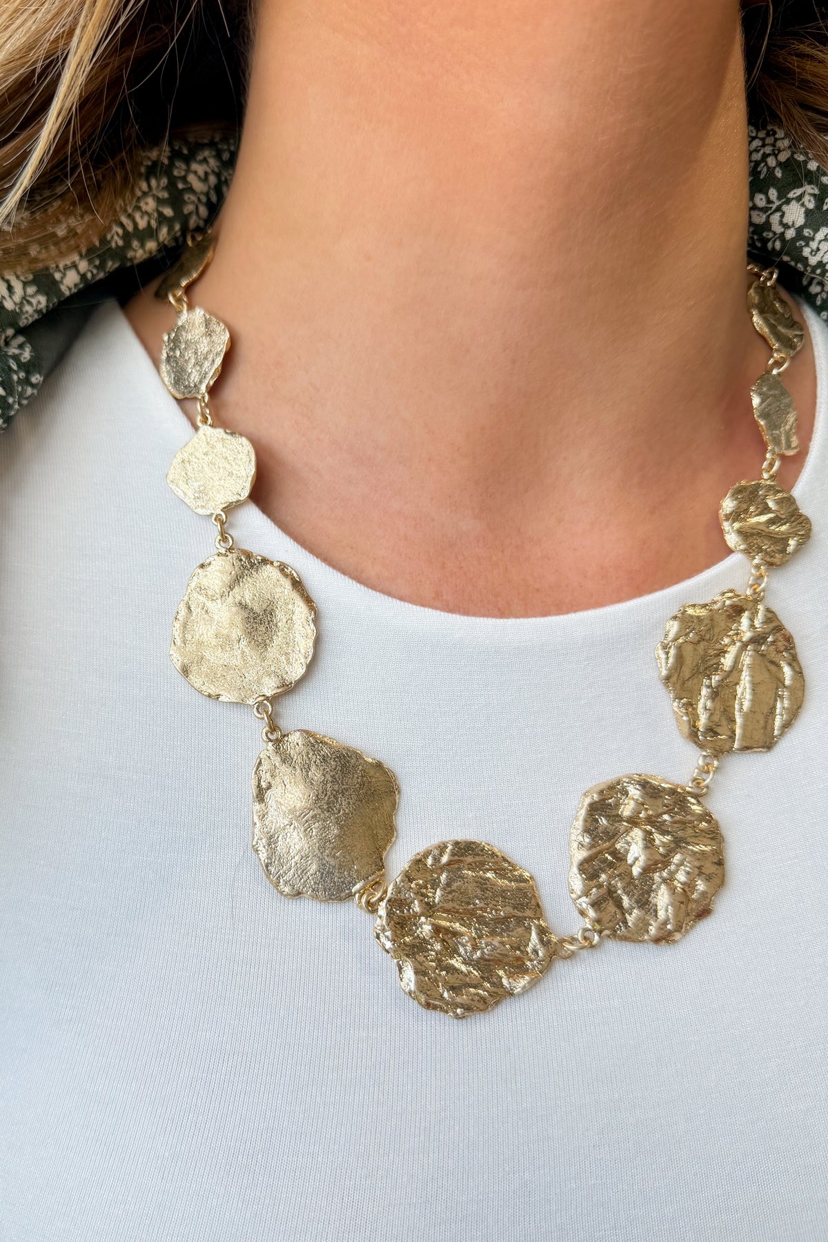 Caroline Hill Ingham textured round necklace showcasing a polished, circular jewelry piece with intricate surface detailing.