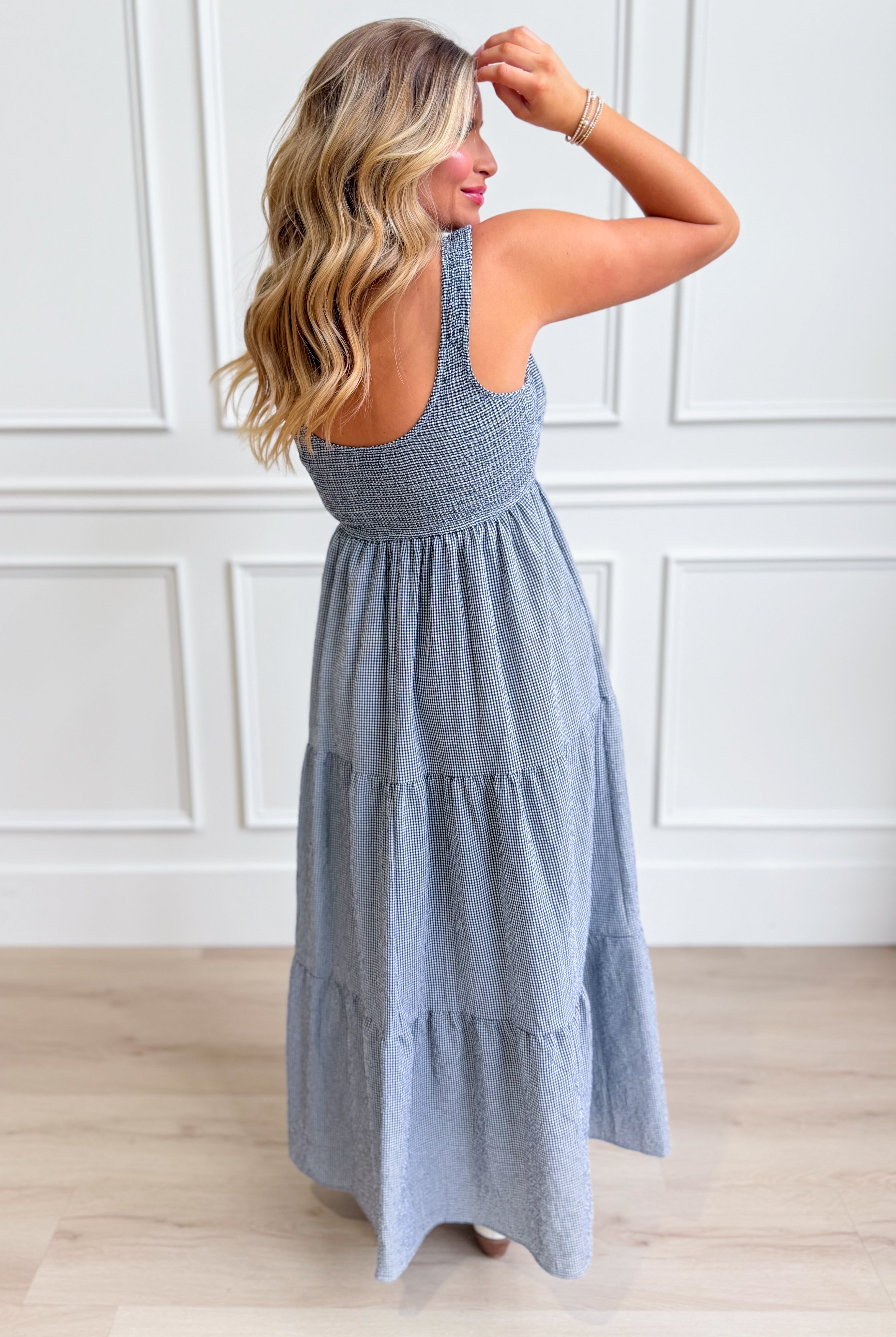 Baevely Painter Gingham Midi Dress displayed on a hanger, featuring a classic gingham pattern and a stylish midi length.