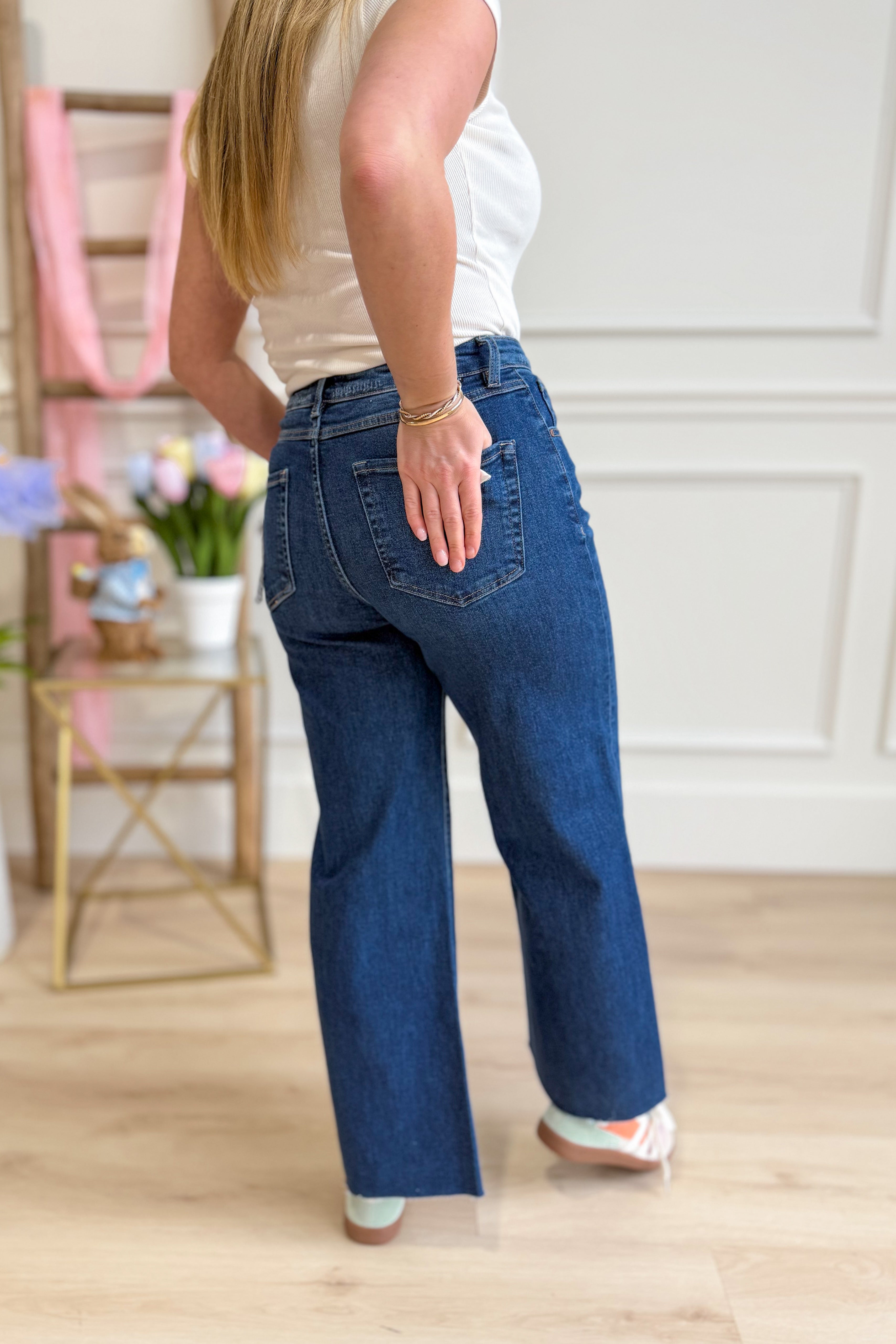 Risen Stevie high-rise crop wide-leg tummy control jeans in blue denim, with visible stitching and classic five-pocket design.