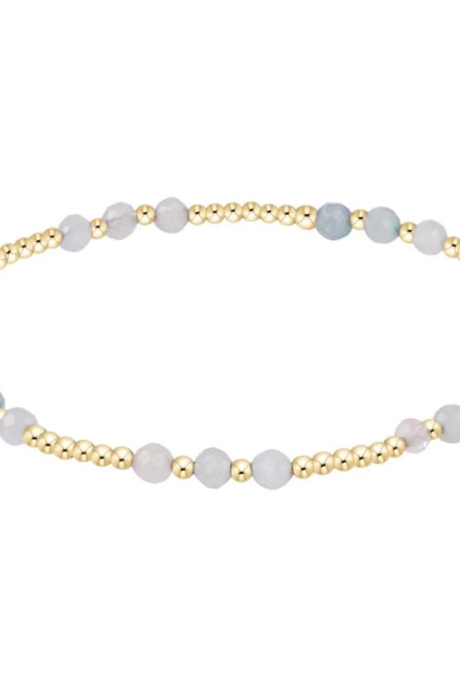 Enewton Aquamarine and gold Joy Gem bracelet with intricate design and gemstone accents, showcasing elegant jewelry craftsmanship.