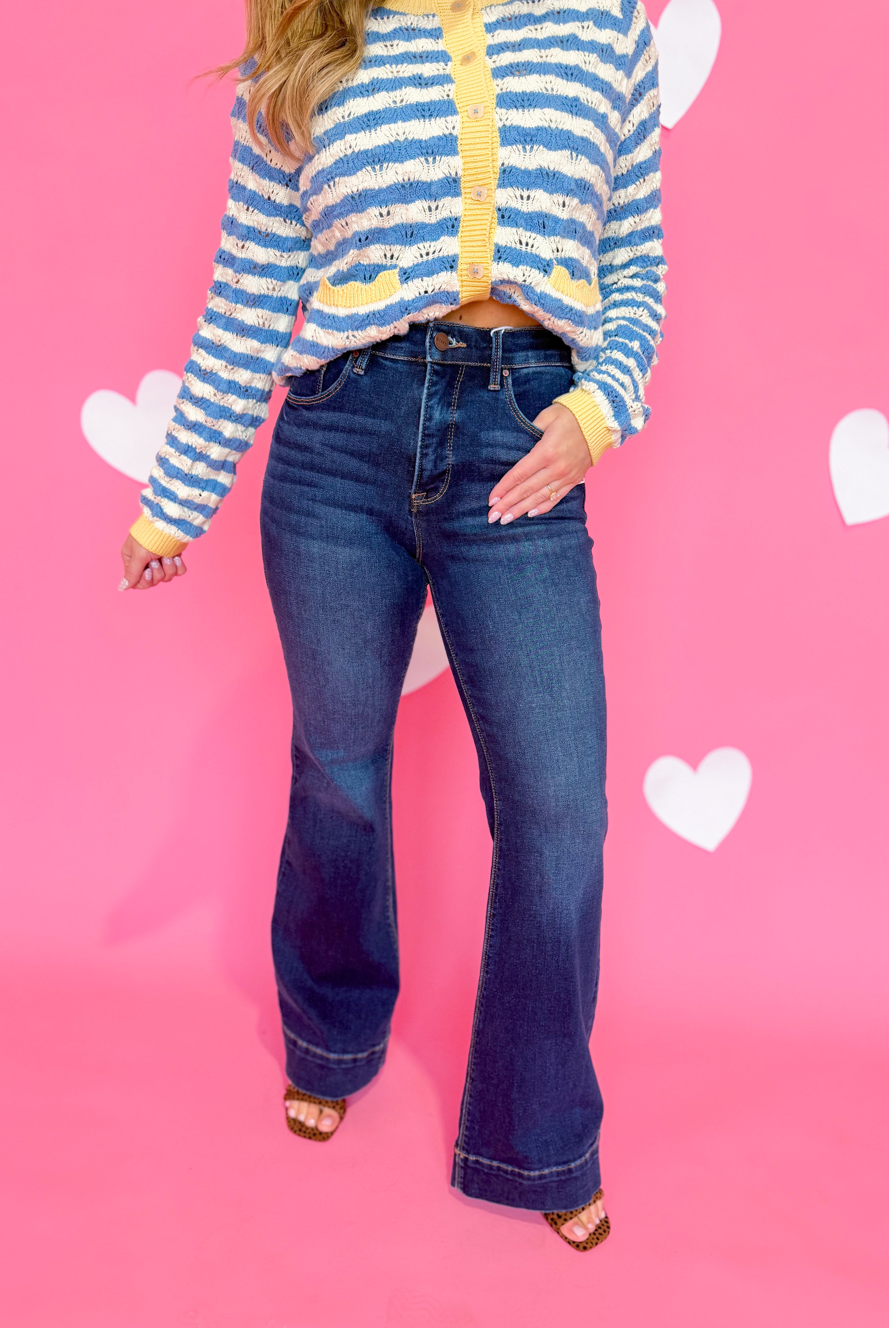 Risen Linus high rise flare jeans with tummy control, shown in dark denim, featuring a fitted waist and flared leg style.