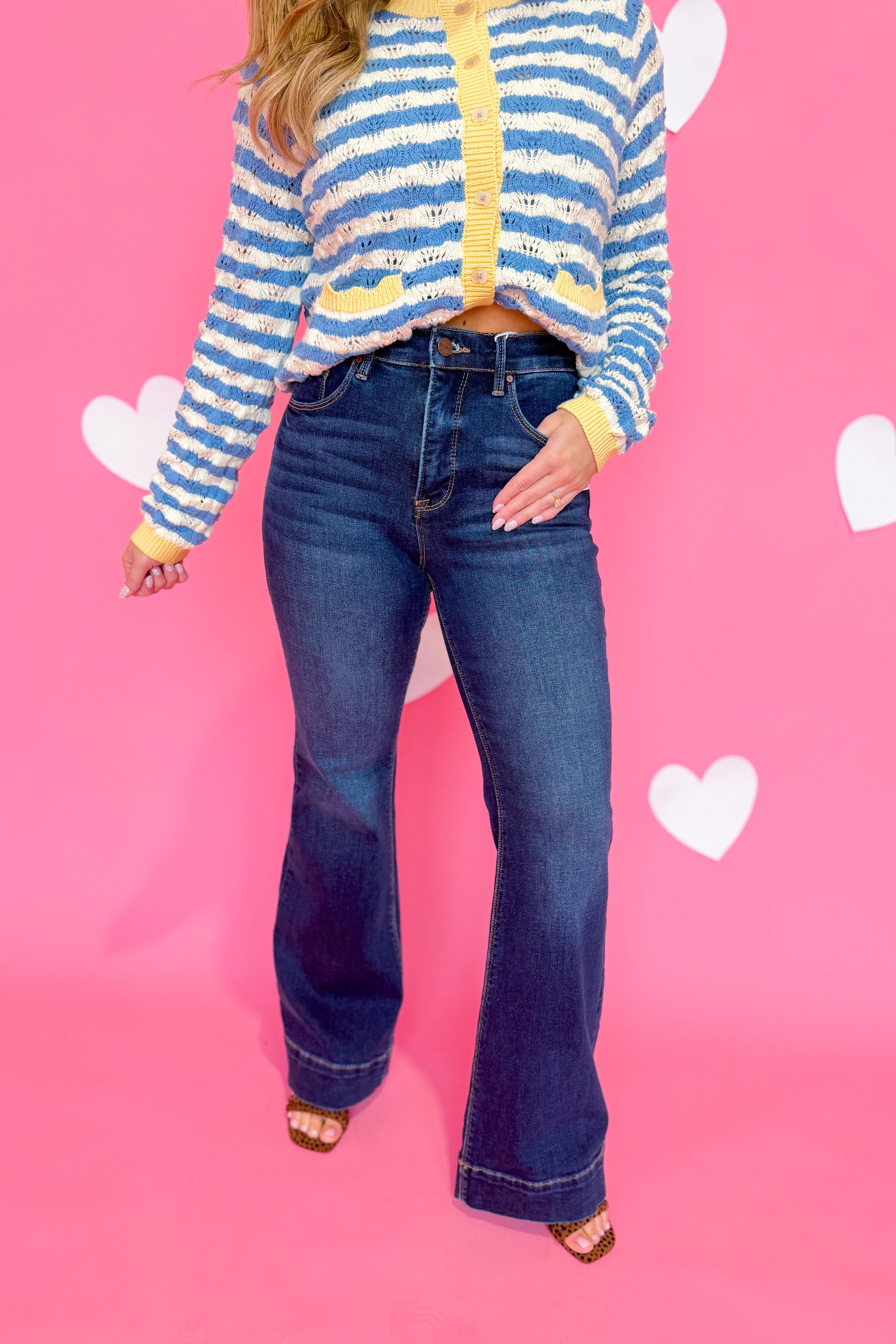 Risen Linus high rise flare jeans with tummy control, shown in dark denim, featuring a fitted waist and flared leg style.