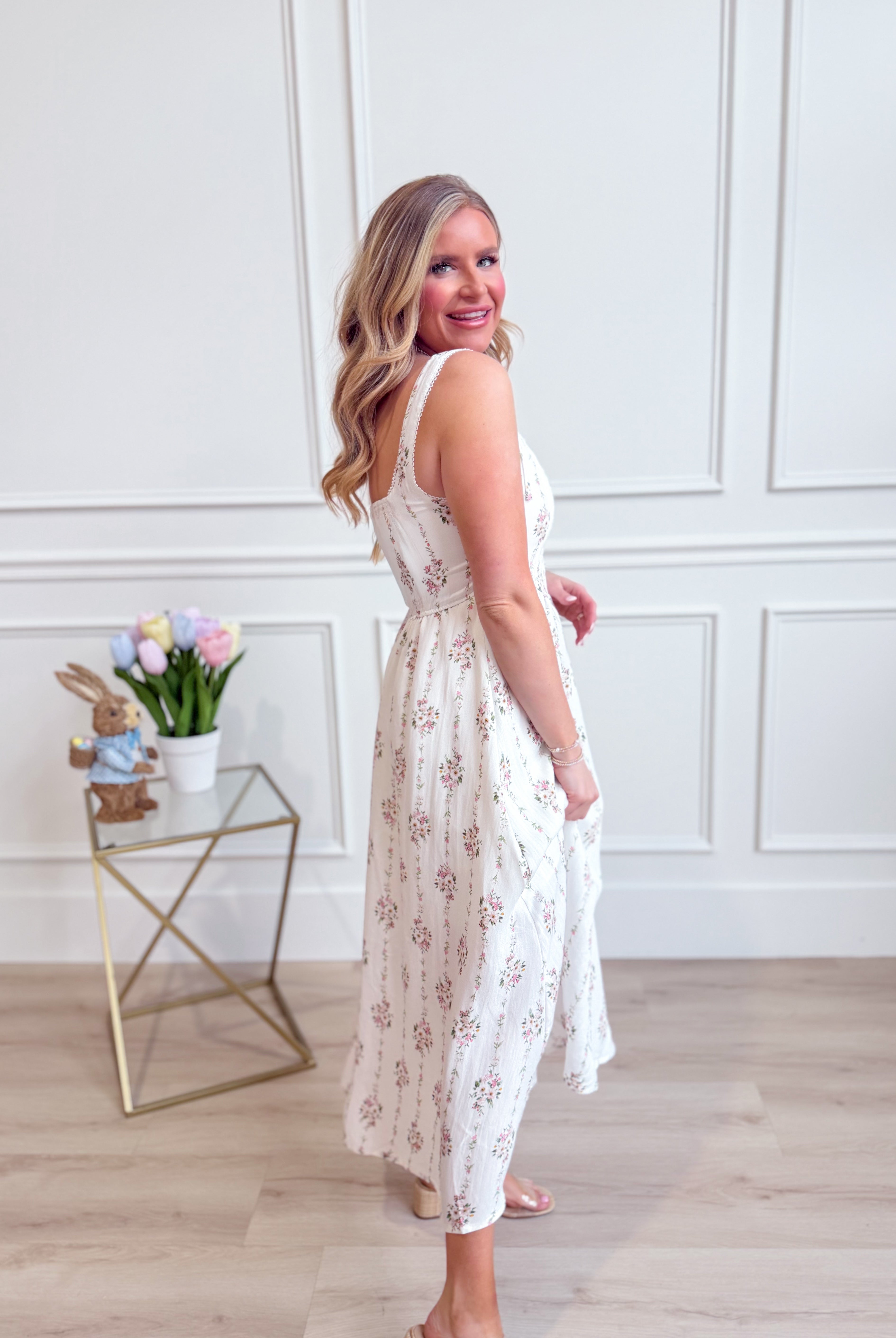 BLU PEPPER Addison floral sleeveless midi dress with a fitted bodice and flowy skirt, featuring vibrant floral patterns.