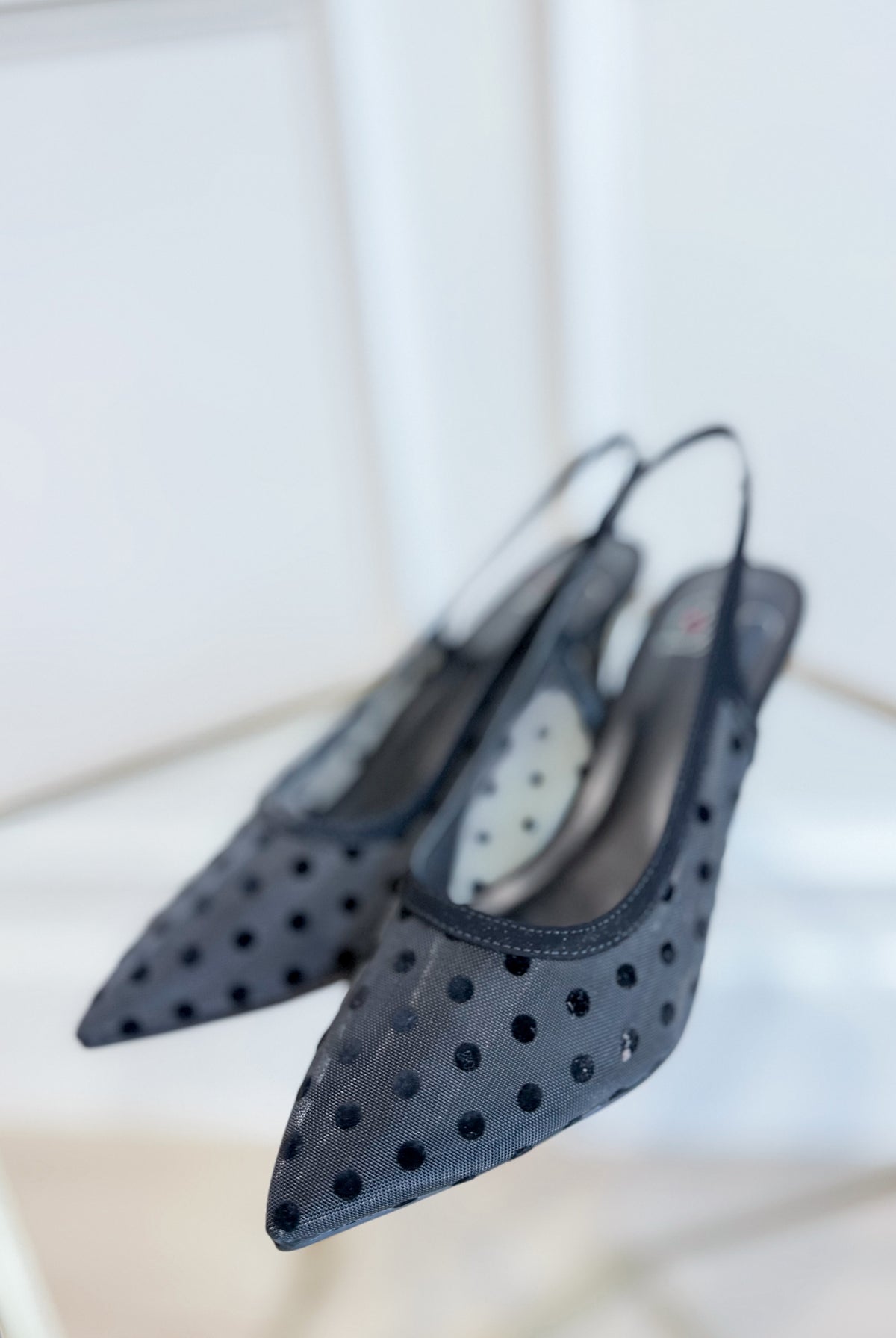 FASHION DYNAMIC next polka dot kitten heel shoe with a sleek design, black and white polka dots, and a comfortable kitten heel style.