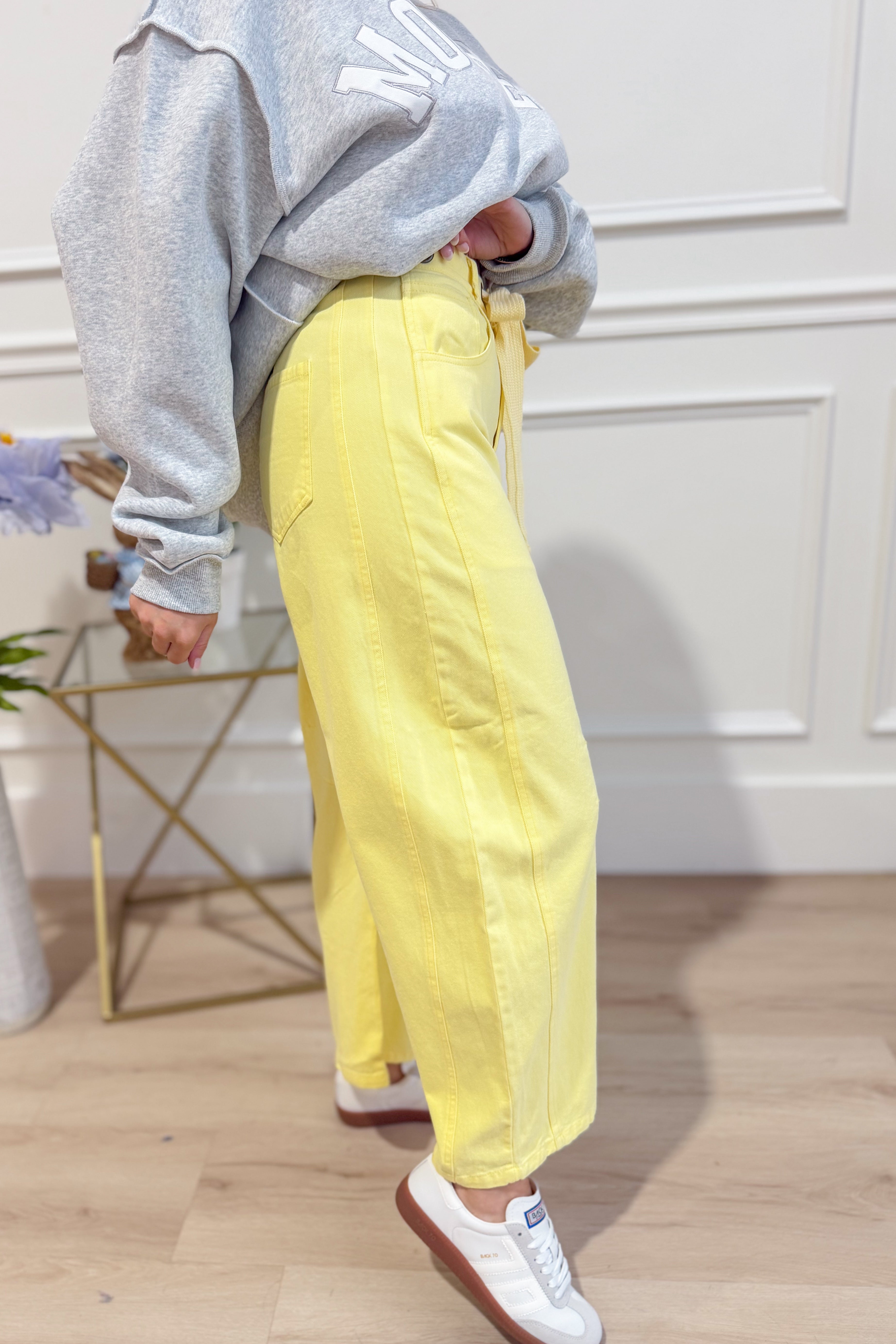 Light yellow mineral washed PEACH LOVE Candice 147 novelty barrel jeans with eyelet details and relaxed fit.