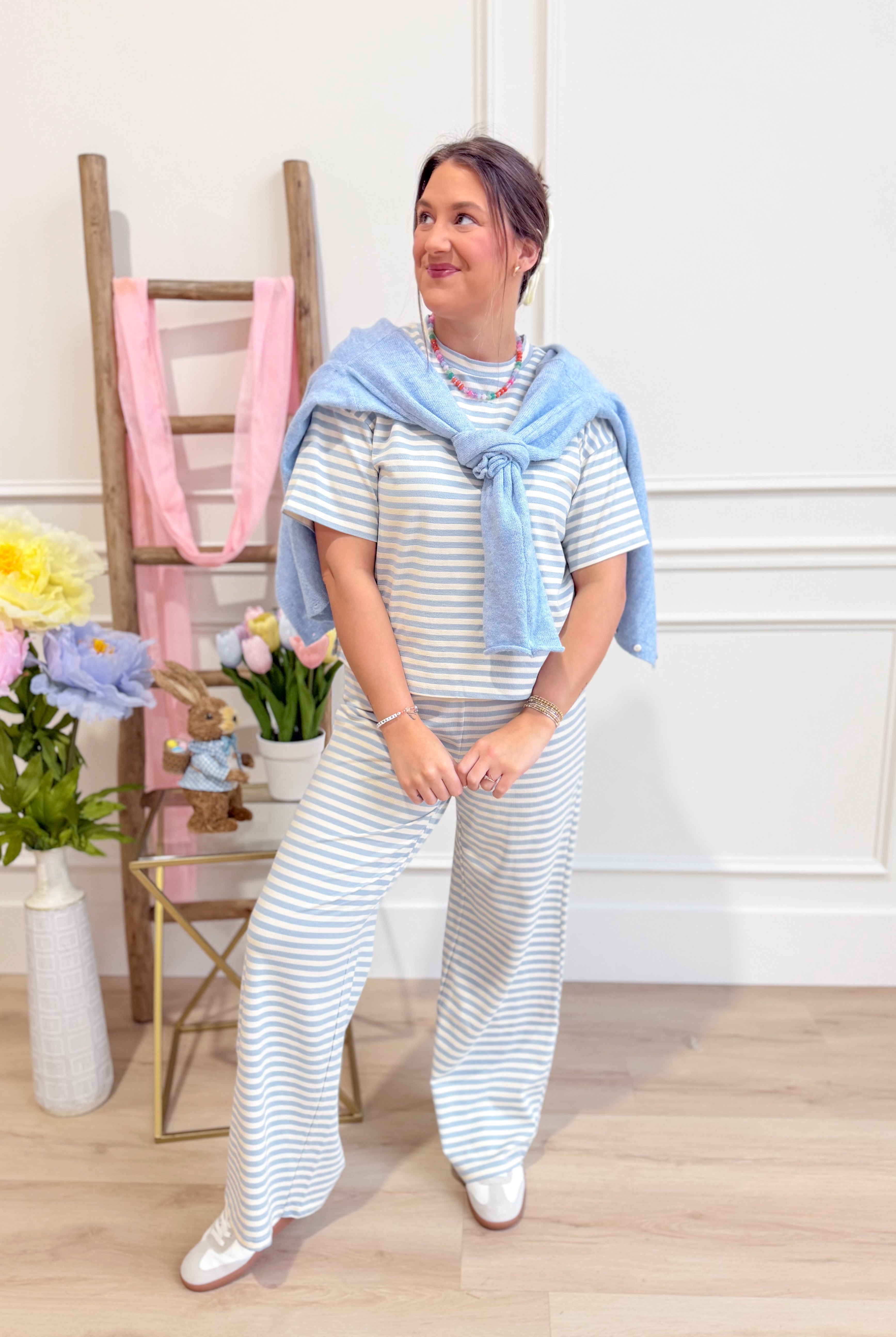 Light blue striped casual top from THINGS BETWEEN, featuring a relaxed fit and soft fabric, ideal for everyday wear.