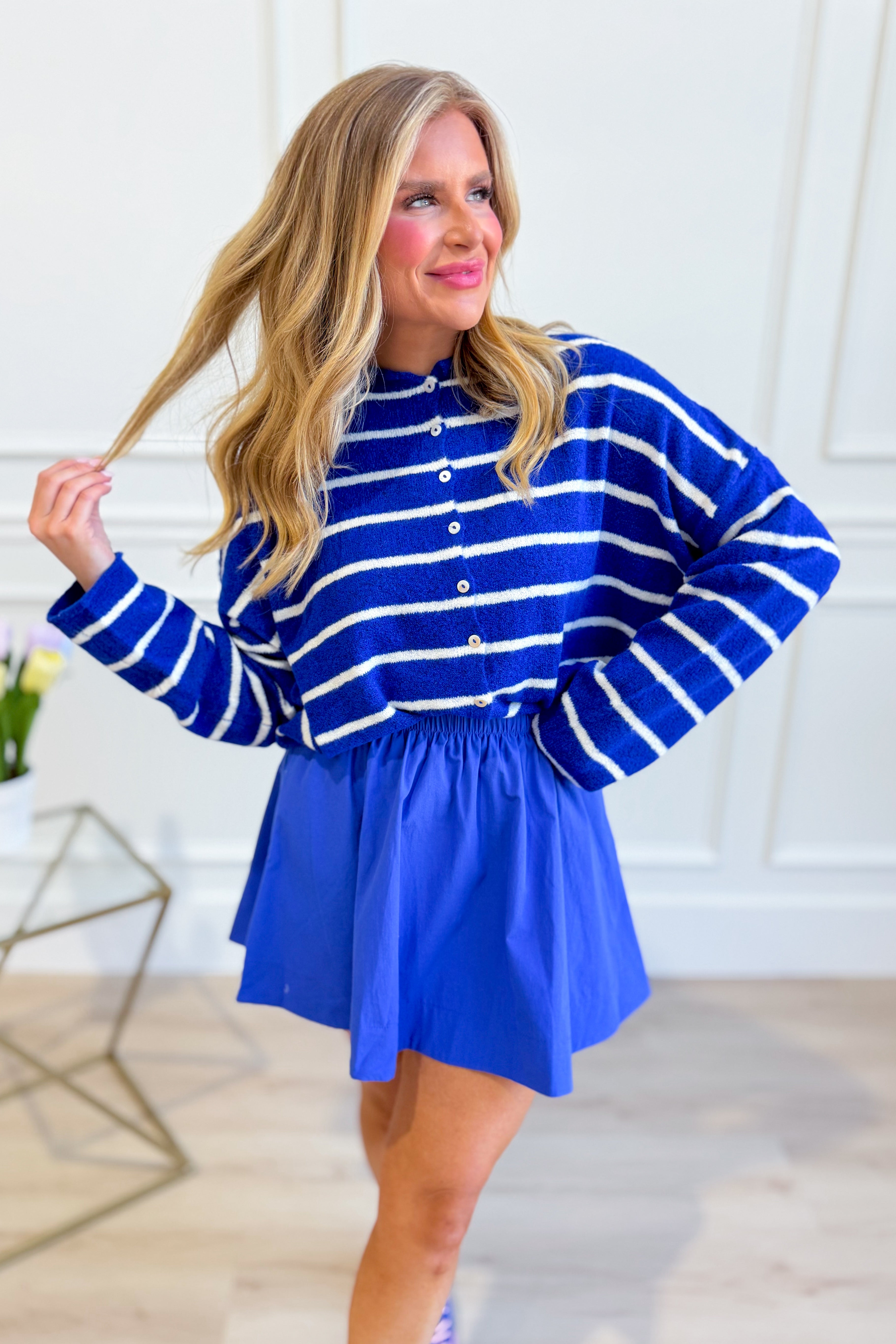Royal blue striped button-up cardigan from THINGS BETWEEN, a stylish spring sweater with a classic design and button-front closure.