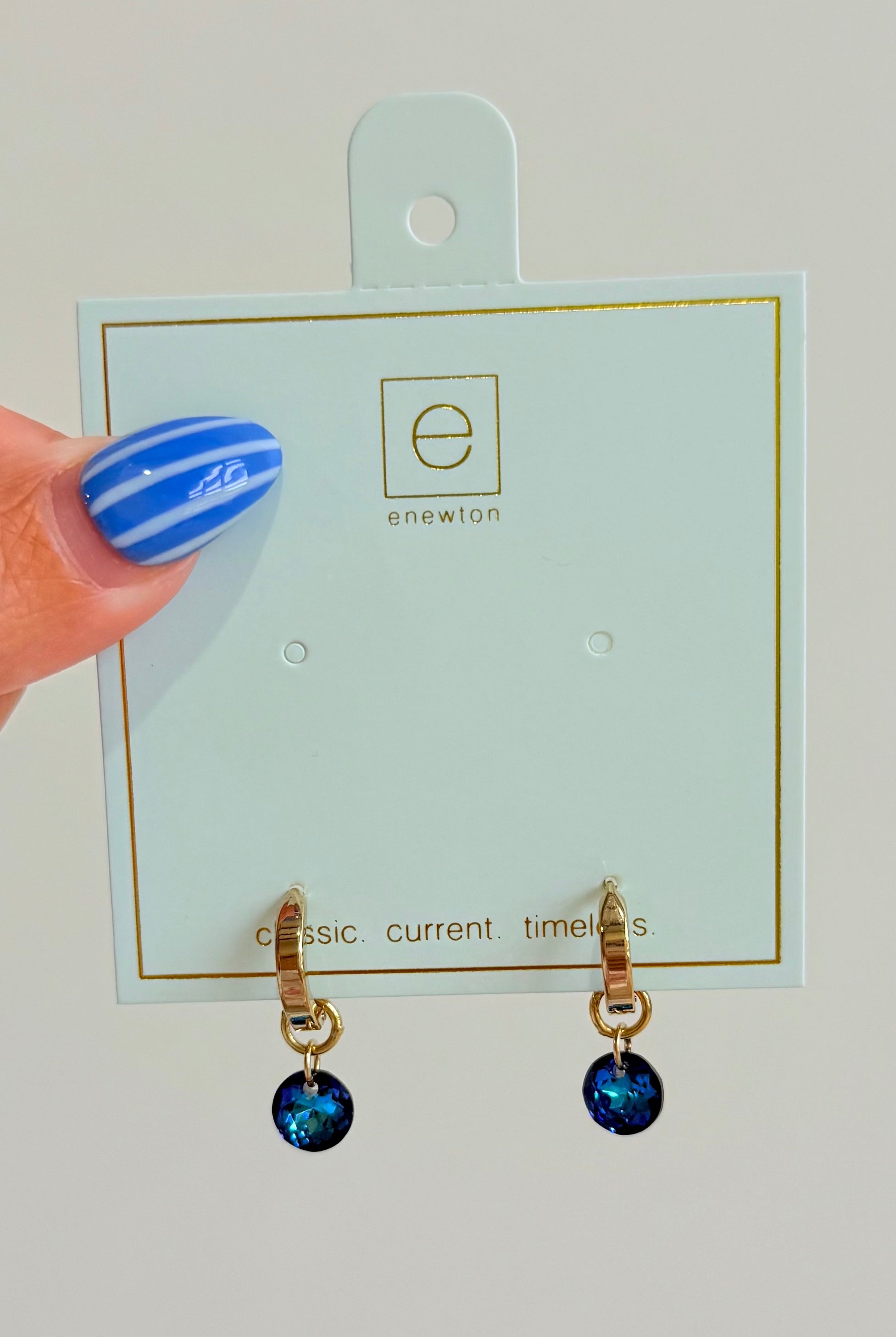 Enewton .5mm Classic Birthstone Huggie earrings featuring a small gemstone set in gold-tone jewelry.