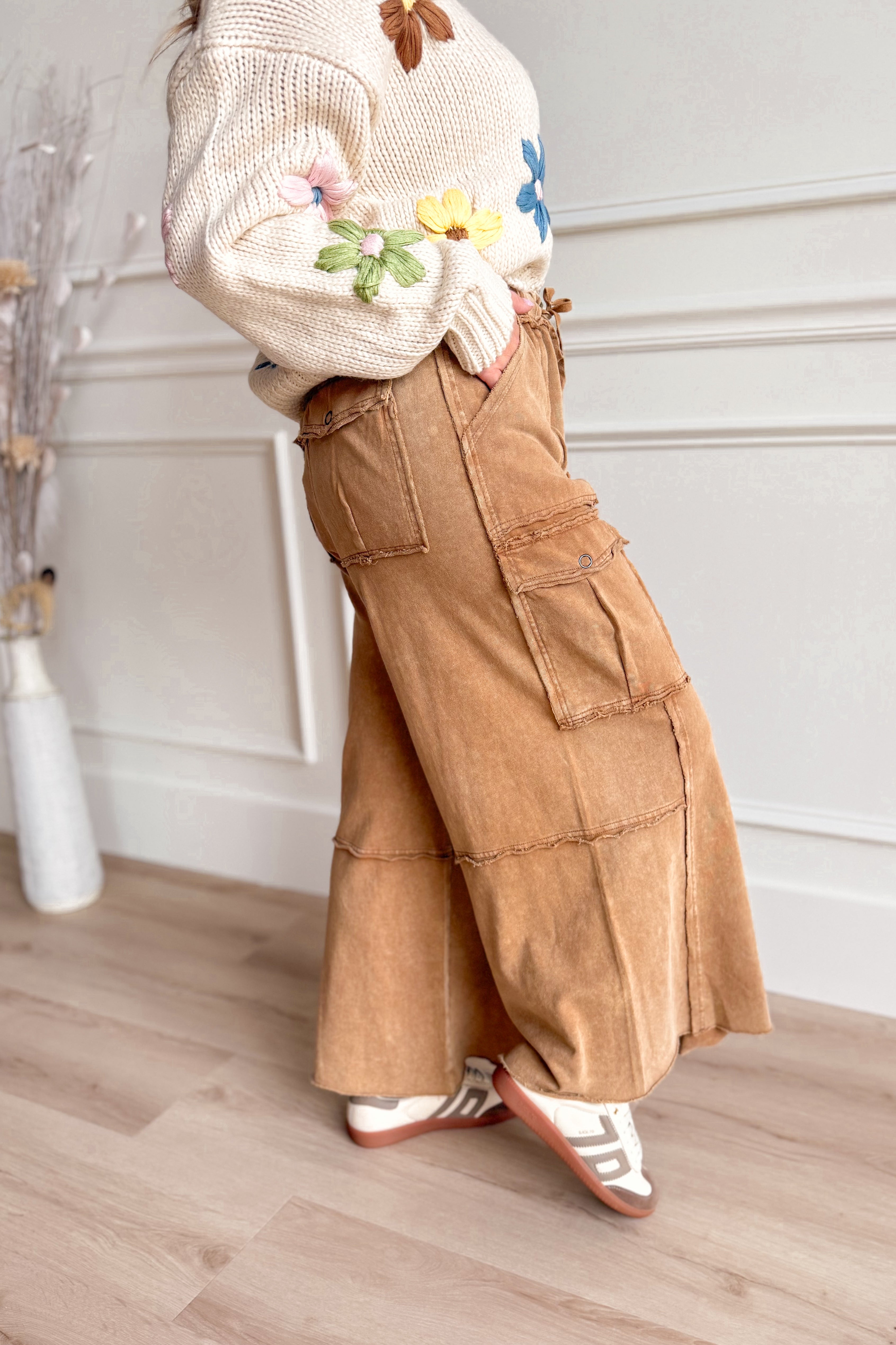 EASEL Mateo mineral washed wide leg cargo pants in neutral tones, featuring multiple pockets and relaxed fit, displayed on a hanger.