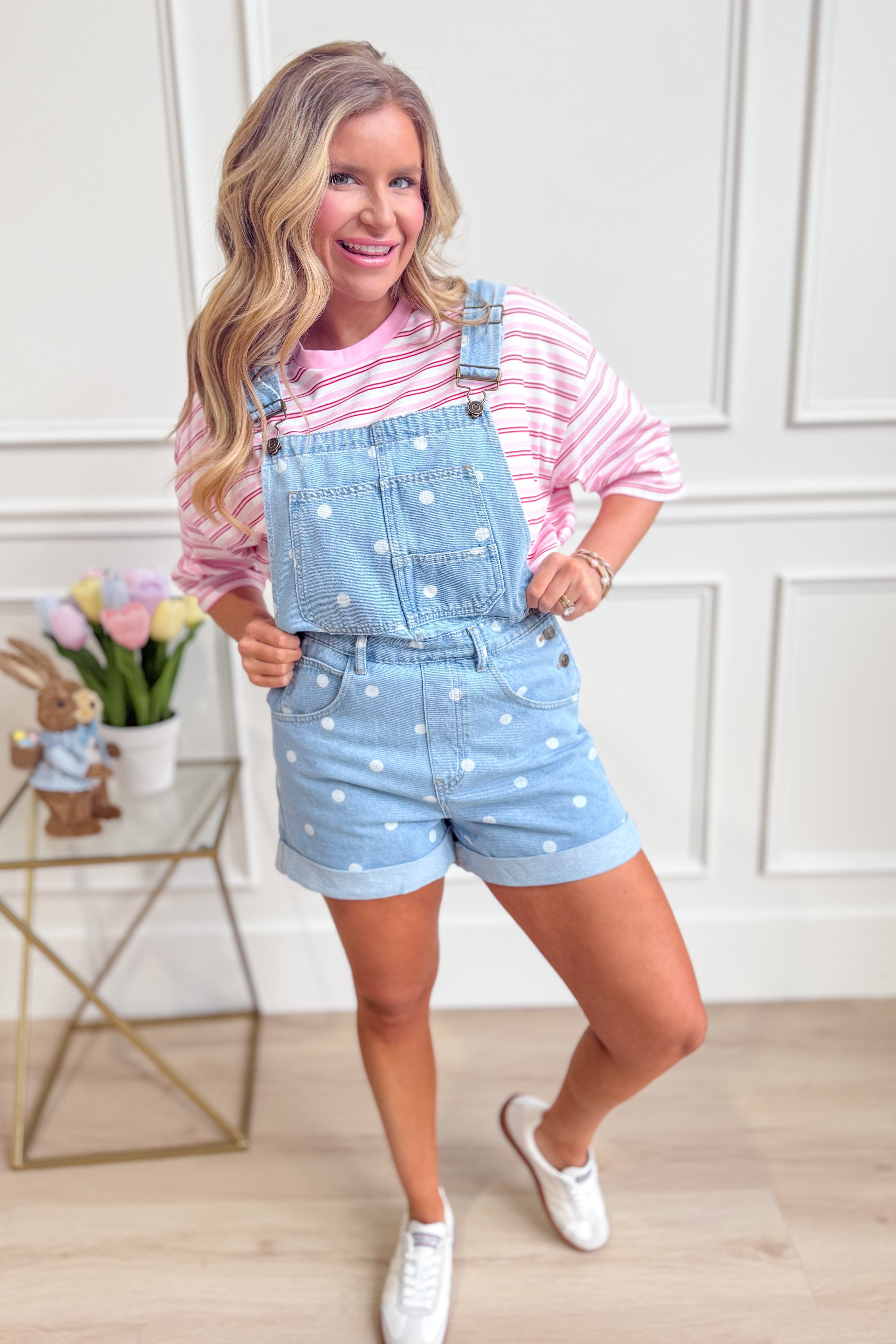 Peach Love Holly polka dot denim overall romper with adjustable straps and front pockets, styled on a model.