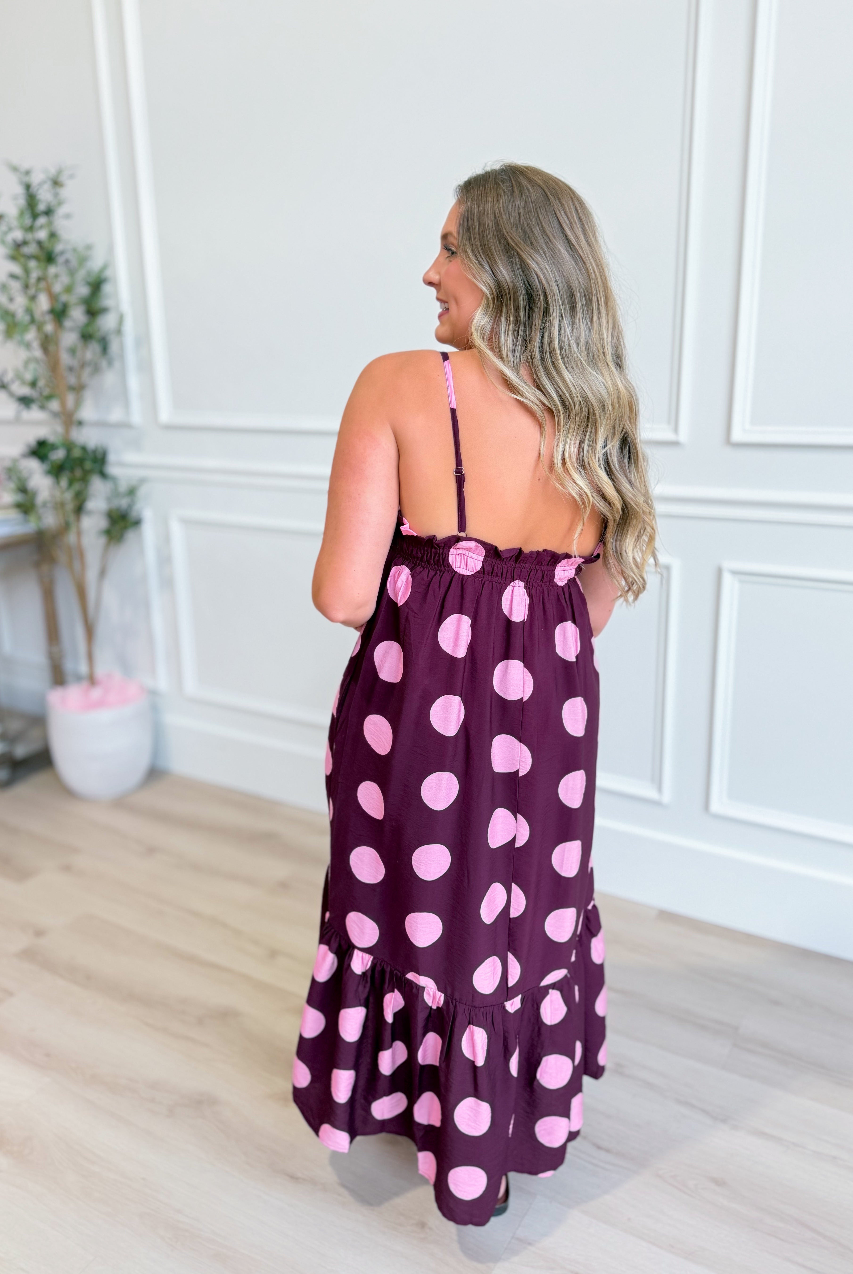 ENTRO Ashton polka dot midi dress featuring a fitted bodice and flowing skirt, perfect for dressy occasions.