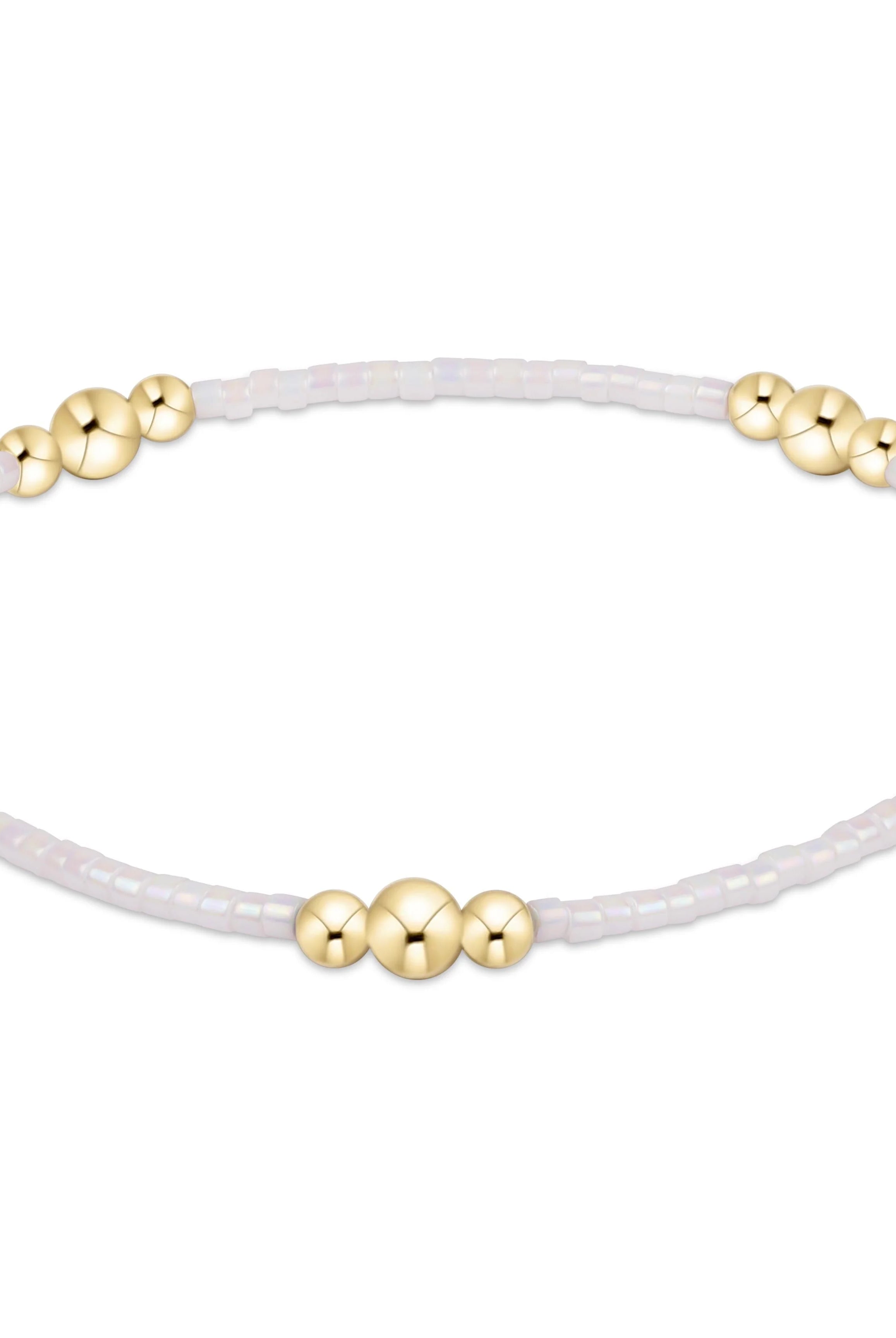 Enewton Silky White Hope Purpose Gold Bracelet featuring sleek gold band and elegant design, on a neutral background.