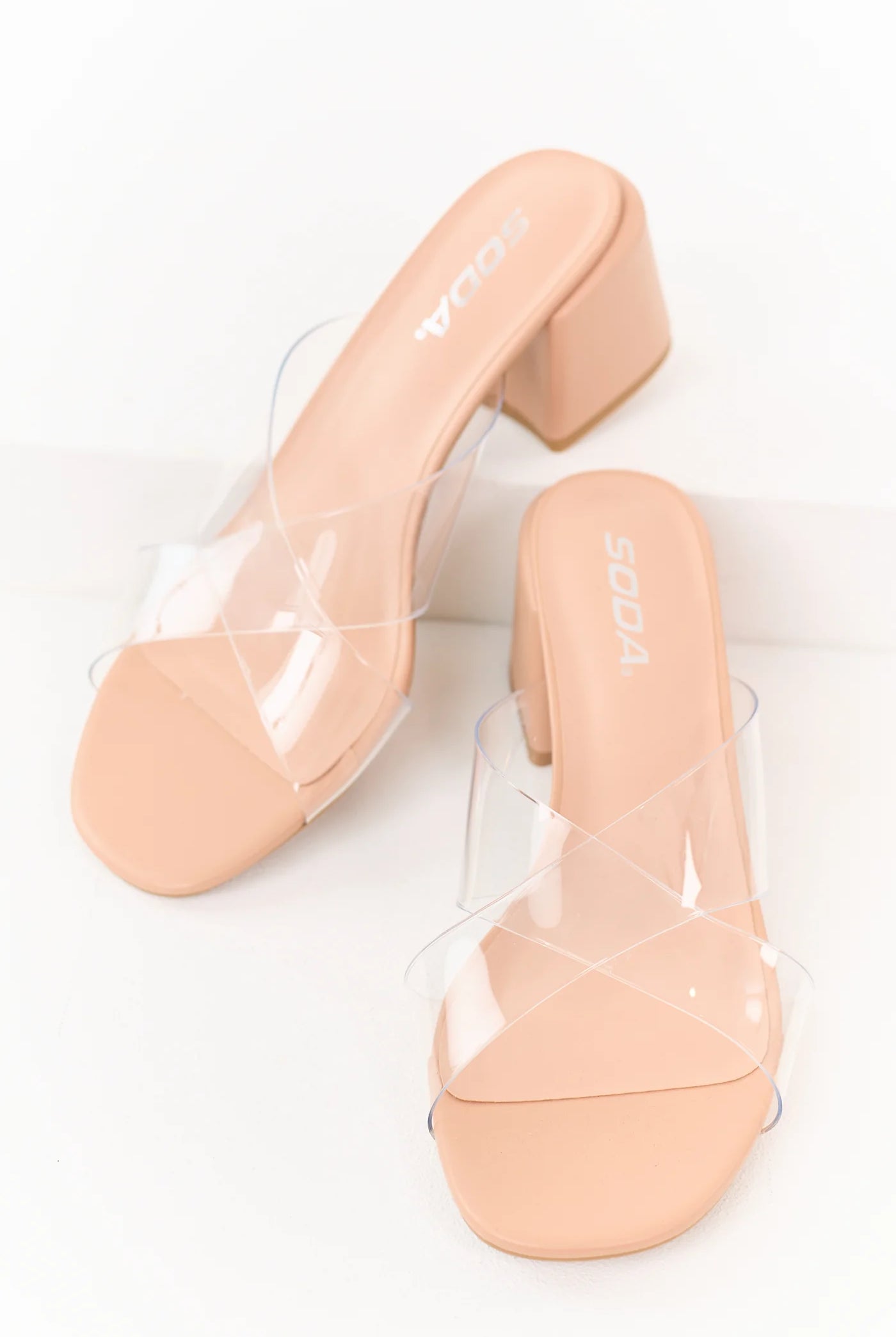 Nude faux leather Sarah Clear Criss Cross Heel by SODA featuring clear cross straps and a block heel for stylish support.