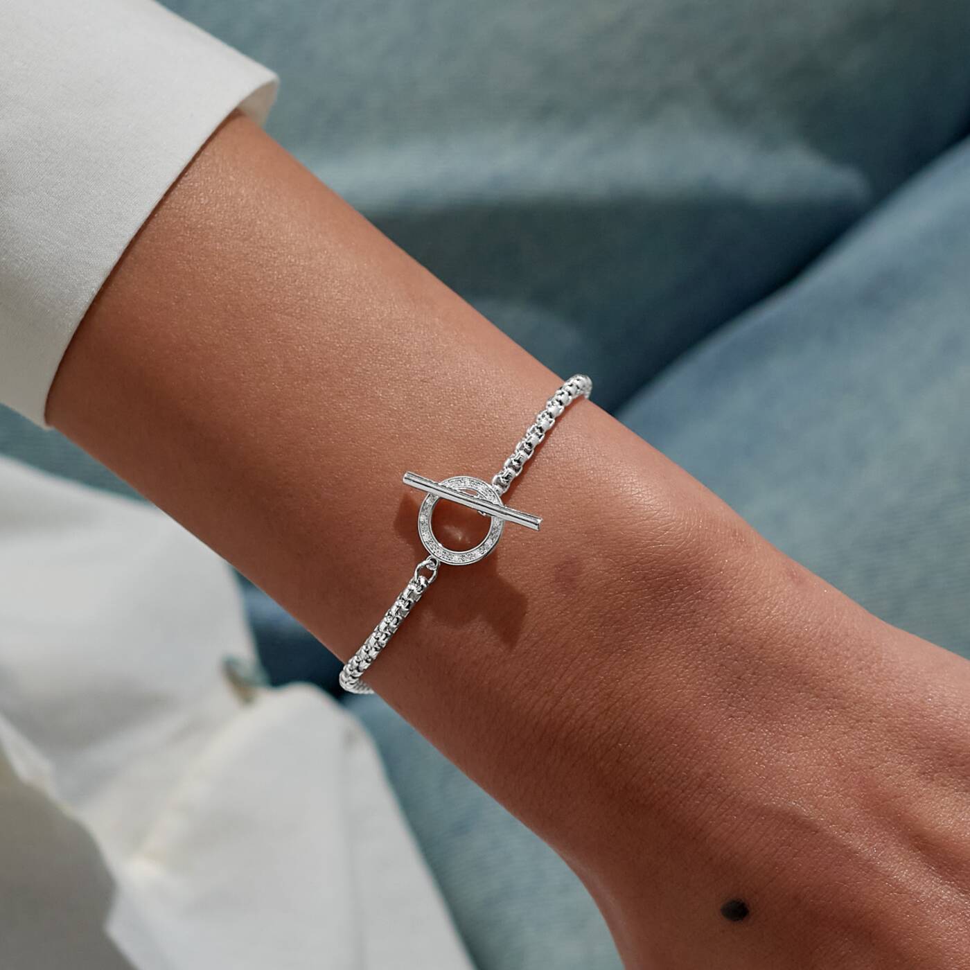 A LITTLES & CO Evermore Circle T Bar bracelet with sleek metal design and minimalist style, displayed on a neutral background.