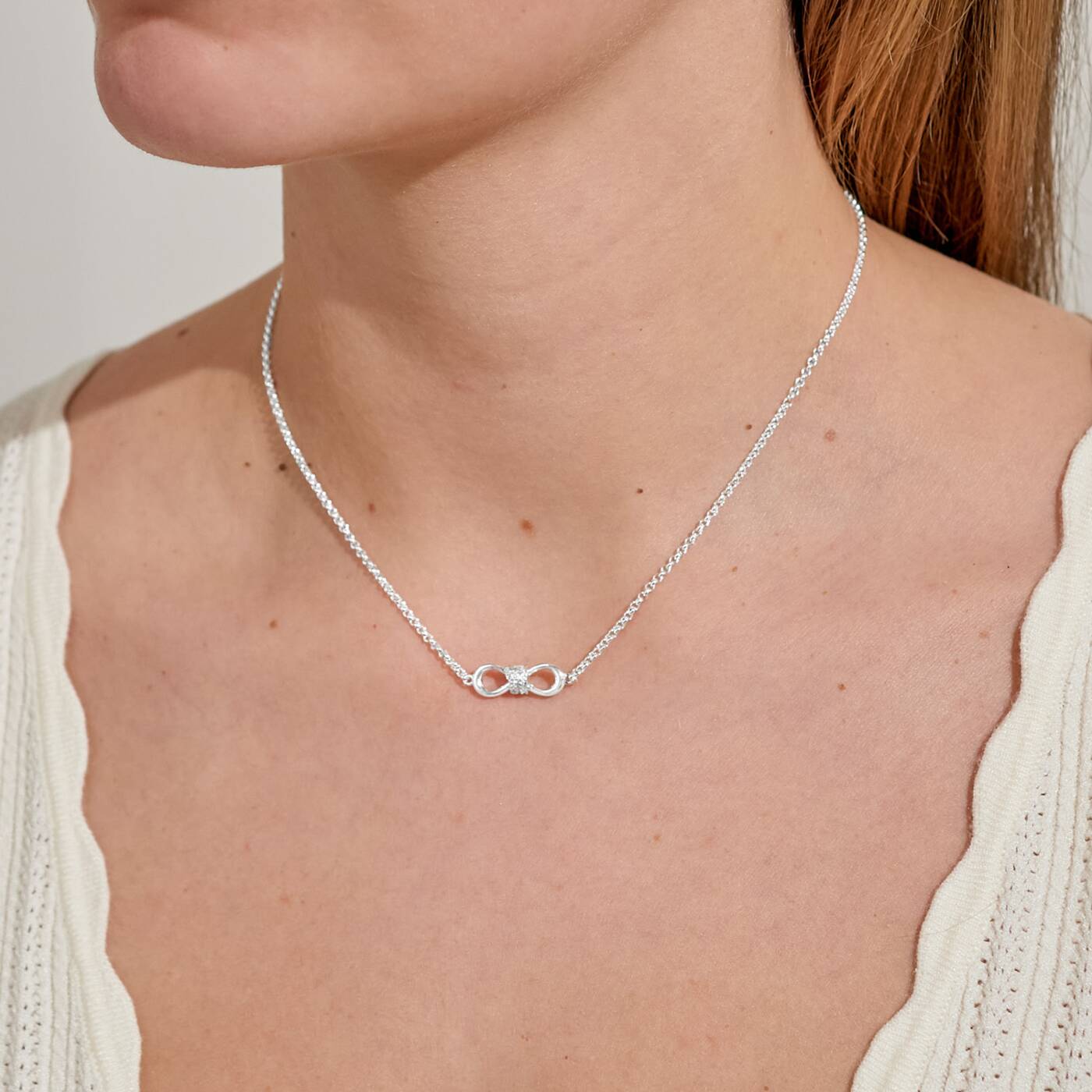 A LITTLES & CO Evermore Infinity Knot 15 3/4-inch necklace with a sleek infinity pendant on a delicate chain.
